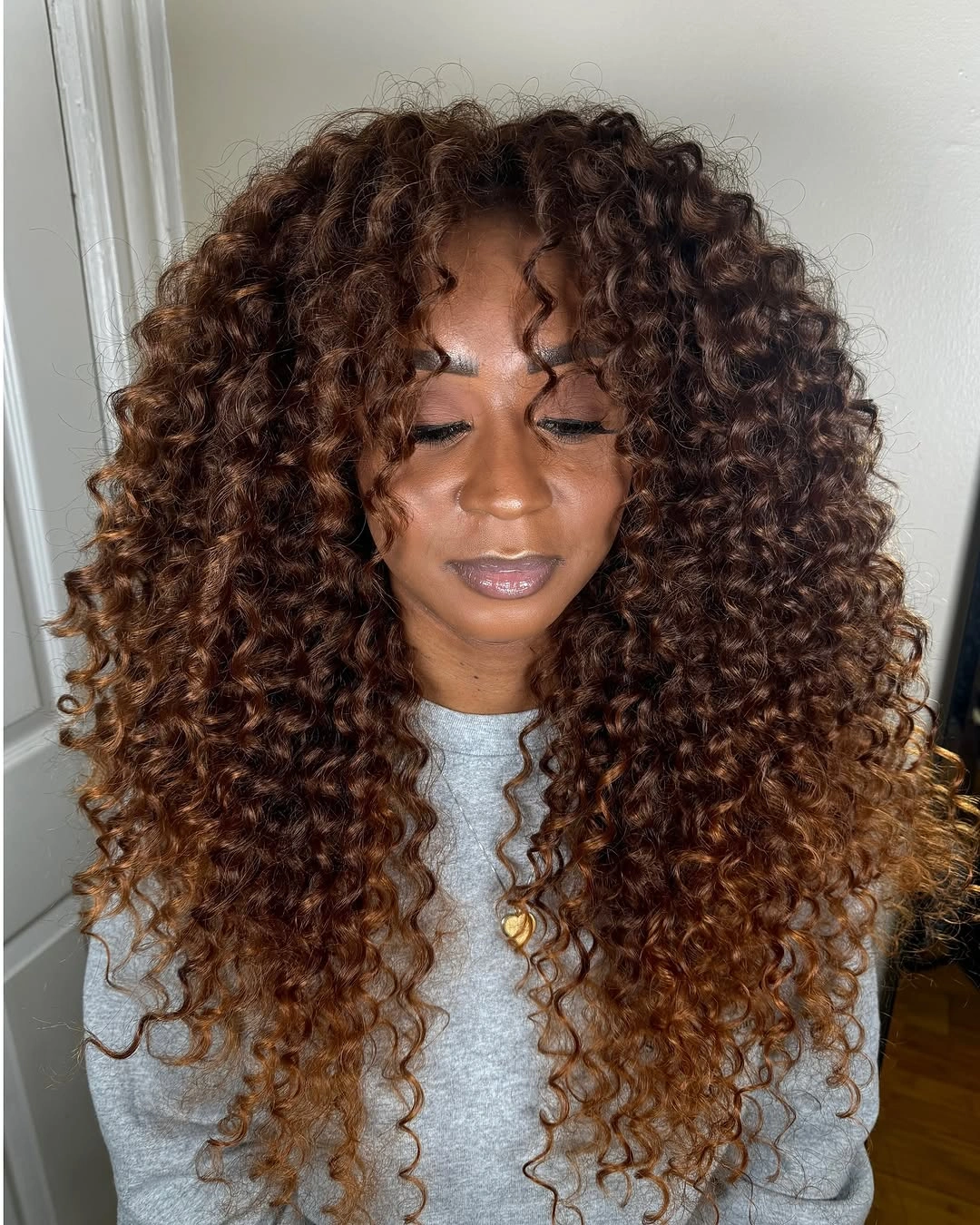 fall hair colors for black women 2026 Caramel Ombre Curls With Cozy Sweater Softness