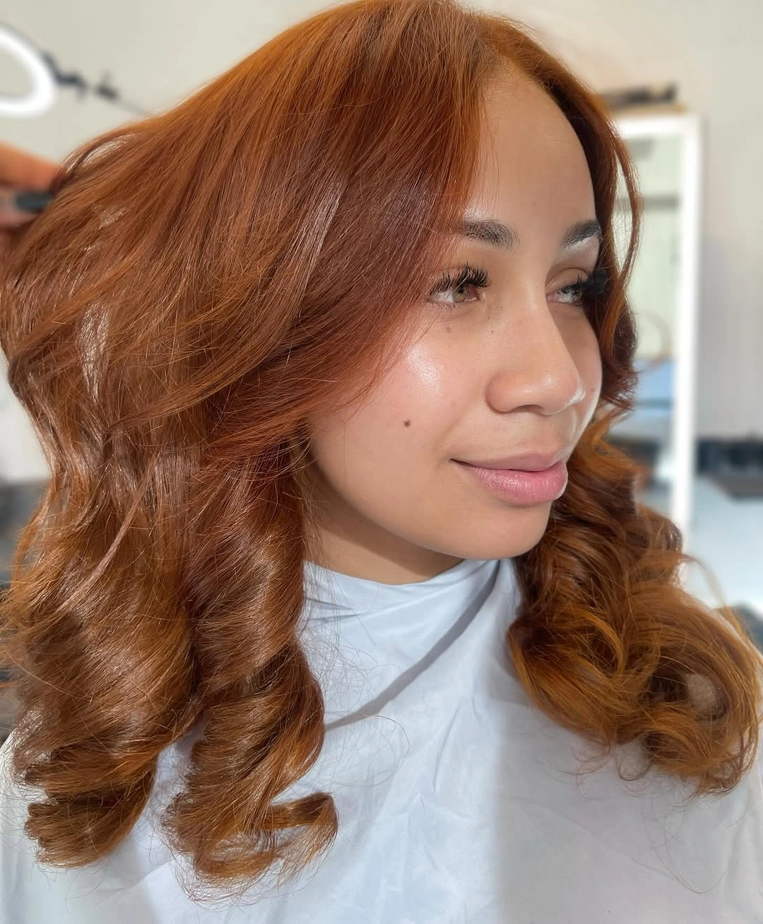 fall hair colors for black women 2026 Soft Cinnamon Waves With a Polished Salon Finish