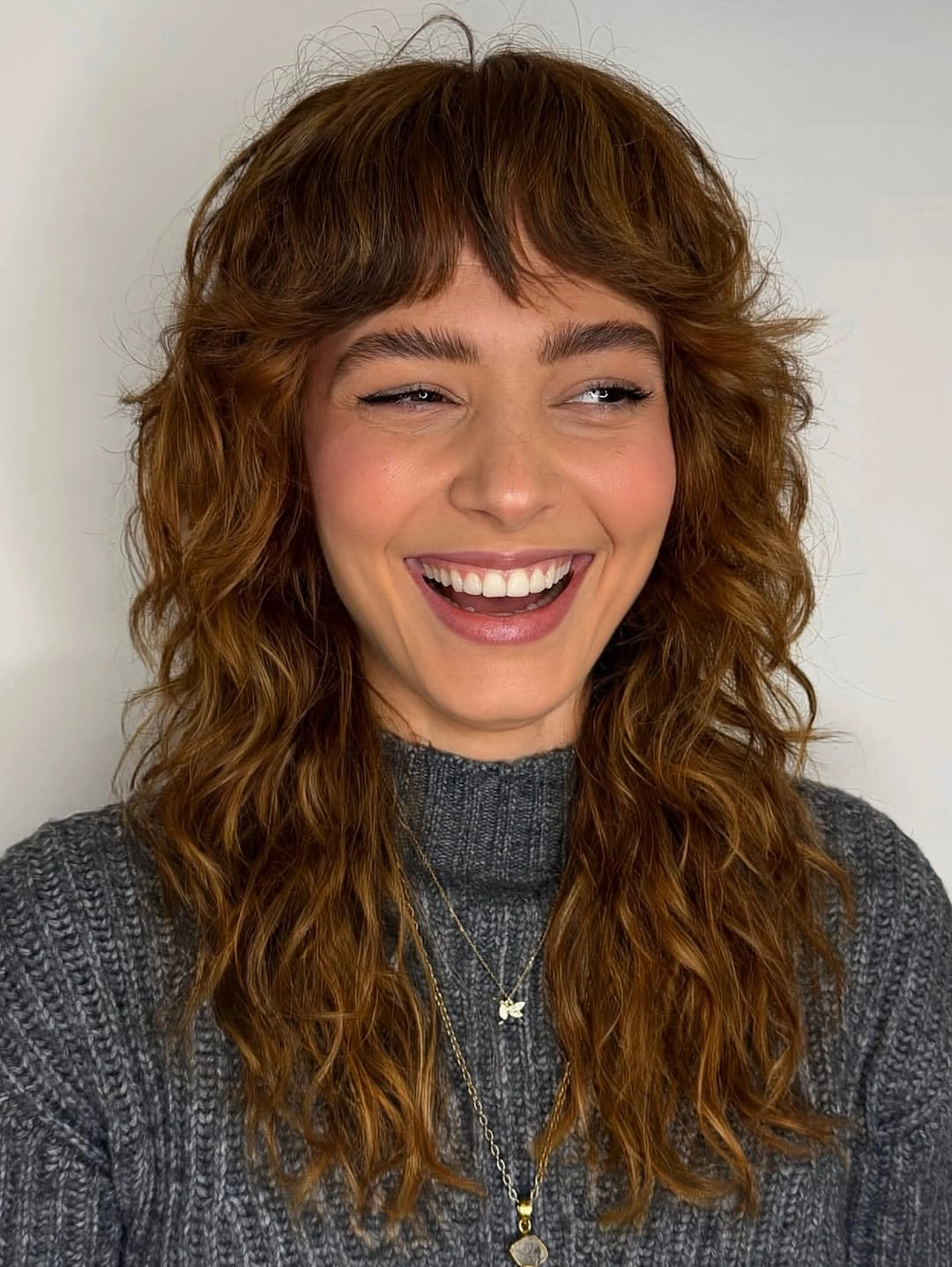 fall haircuts for women 2026 Copper Curly Shag With Soft Bangs