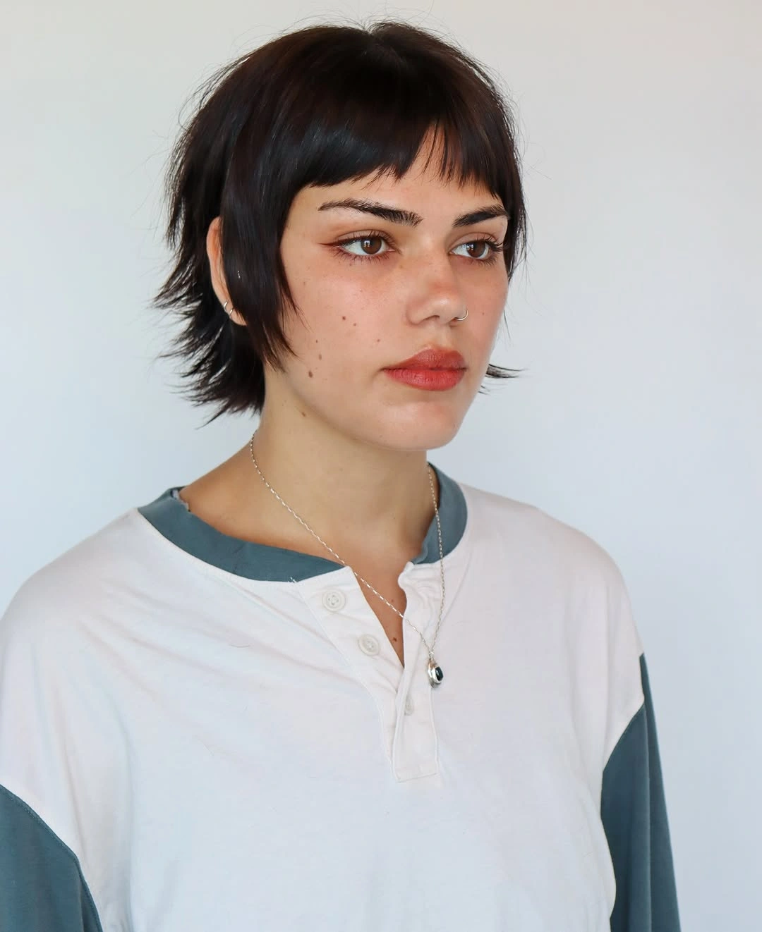 fall haircuts for women 2026 Choppy Mini Wolf Cut With Baby Bangs