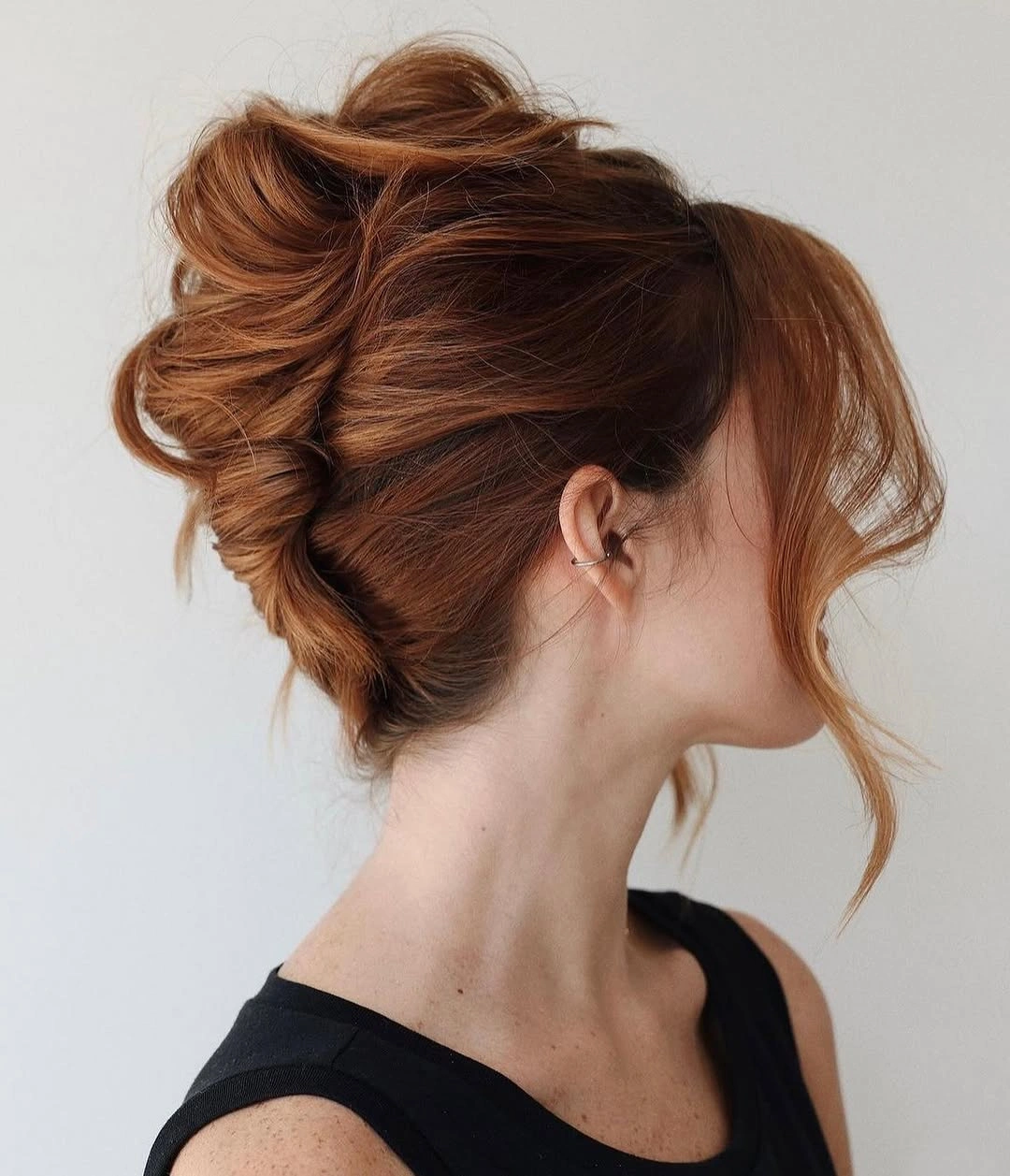 fall hairstyles 2026 Copper Messy Updo With Loose Face Pieces