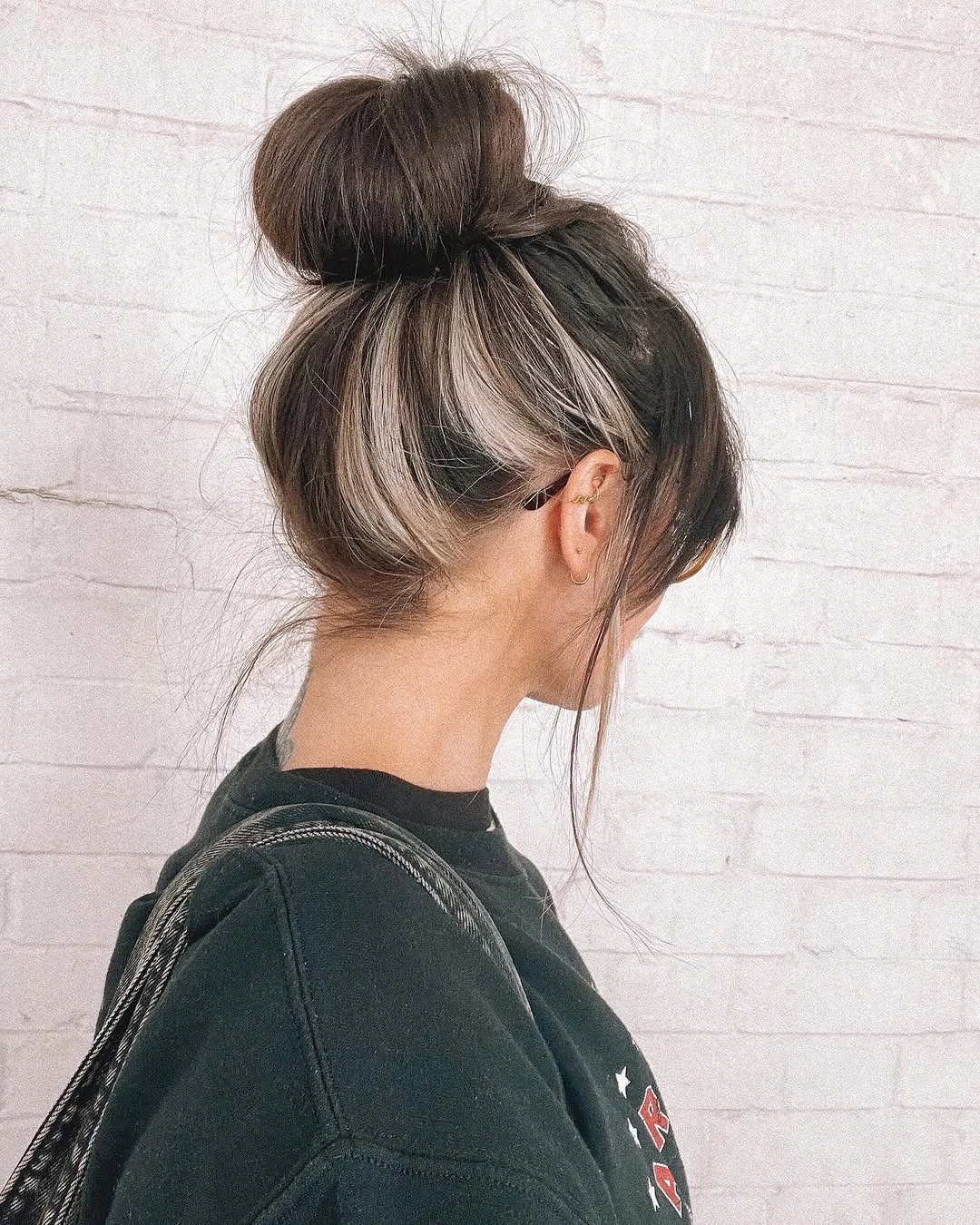 fall hairstyles for long hair 2026 Messy High Bun With Blonde Money-Piece Drama