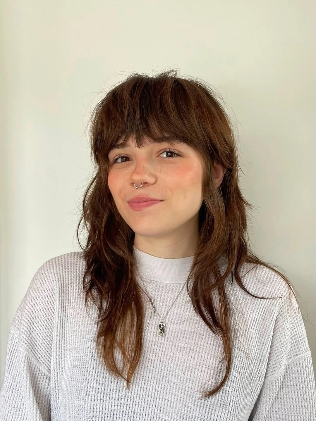 fall hairstyles for long hair 2026 Soft Brunette Shag With Full Bangs and Cozy Knit Texture