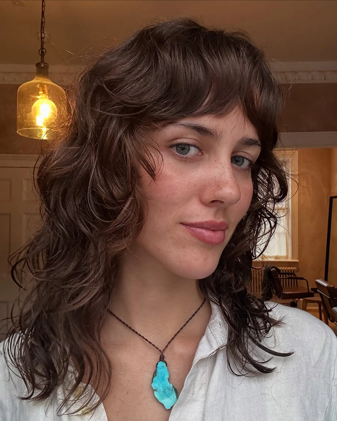 fall hairstyles for long hair 2026 Curly Brunette Shag With Soft Full Bangs