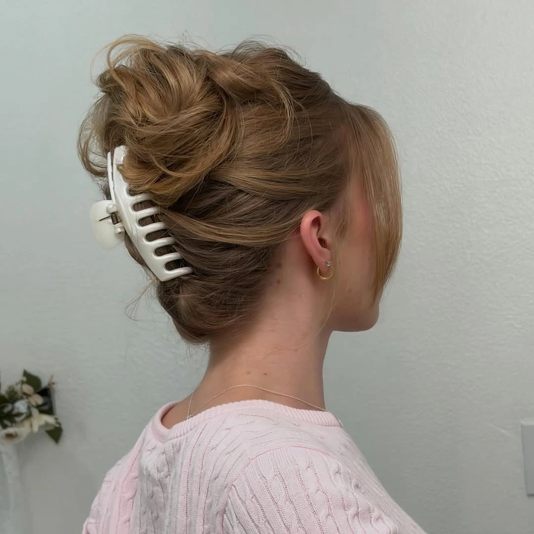 fall hairstyles for office 2026 Soft Claw Clip Updo With Pink Sweater Ease