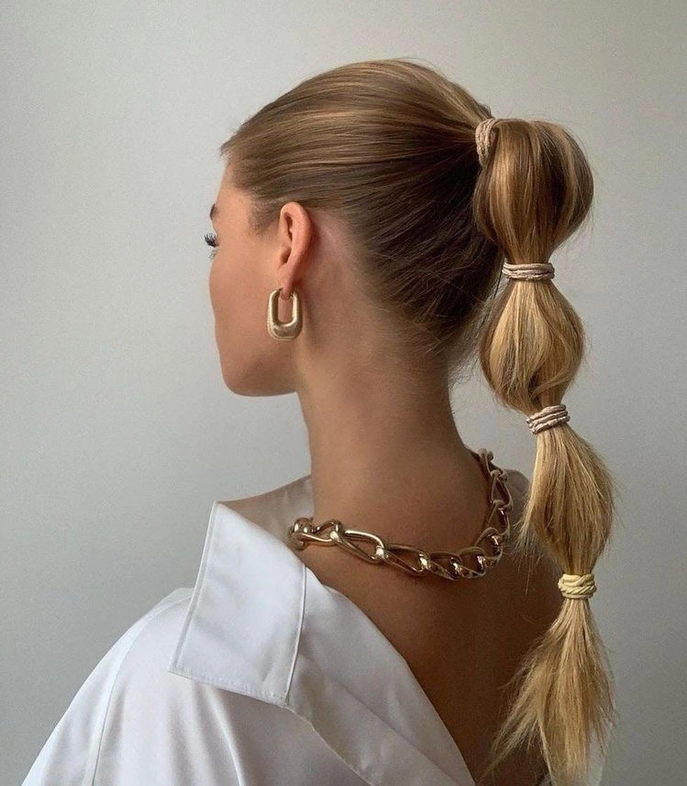 fall hairstyles for office 2026 Sleek Bubble Ponytail With Gold Jewelry