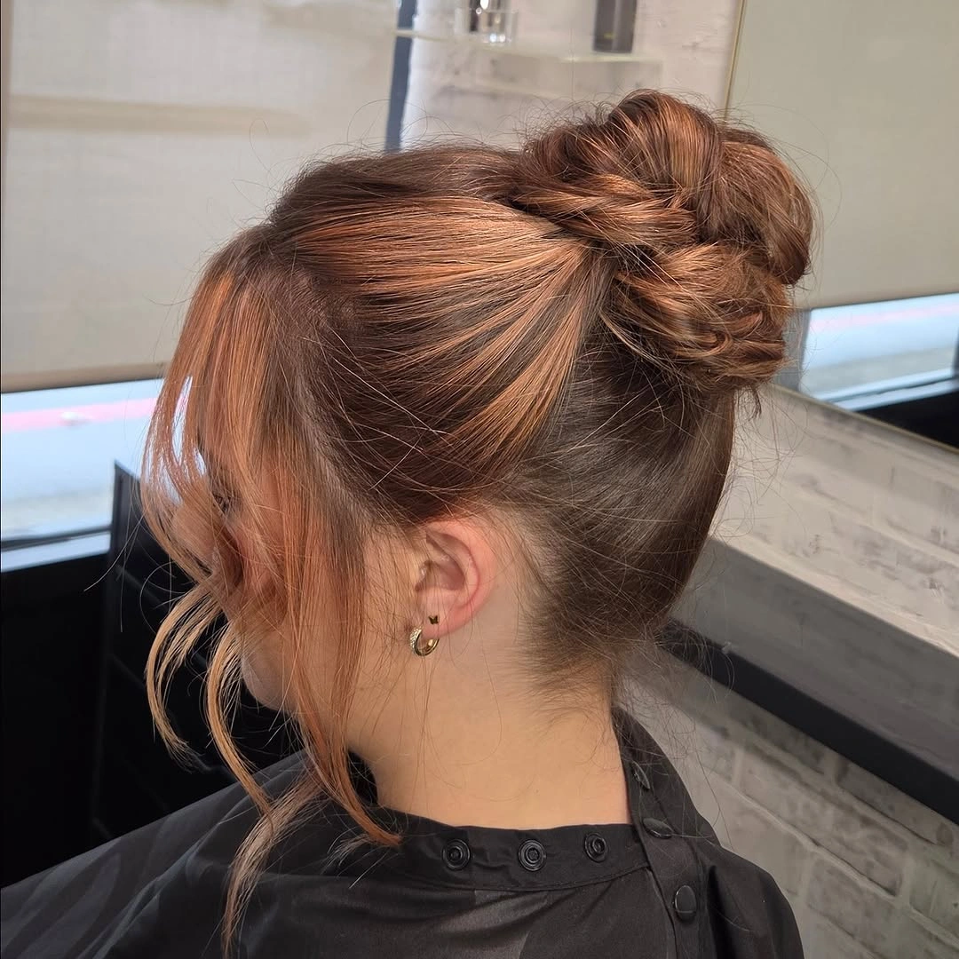 fall hairstyles for office 2026 Copper High Bun With Soft Curtain Pieces