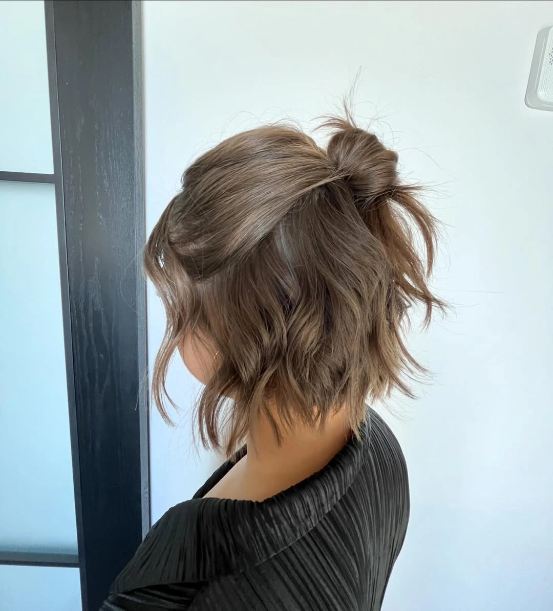 fall hairstyles for short hair 2026 Messy Half-Up Mini Bun For Short Layers