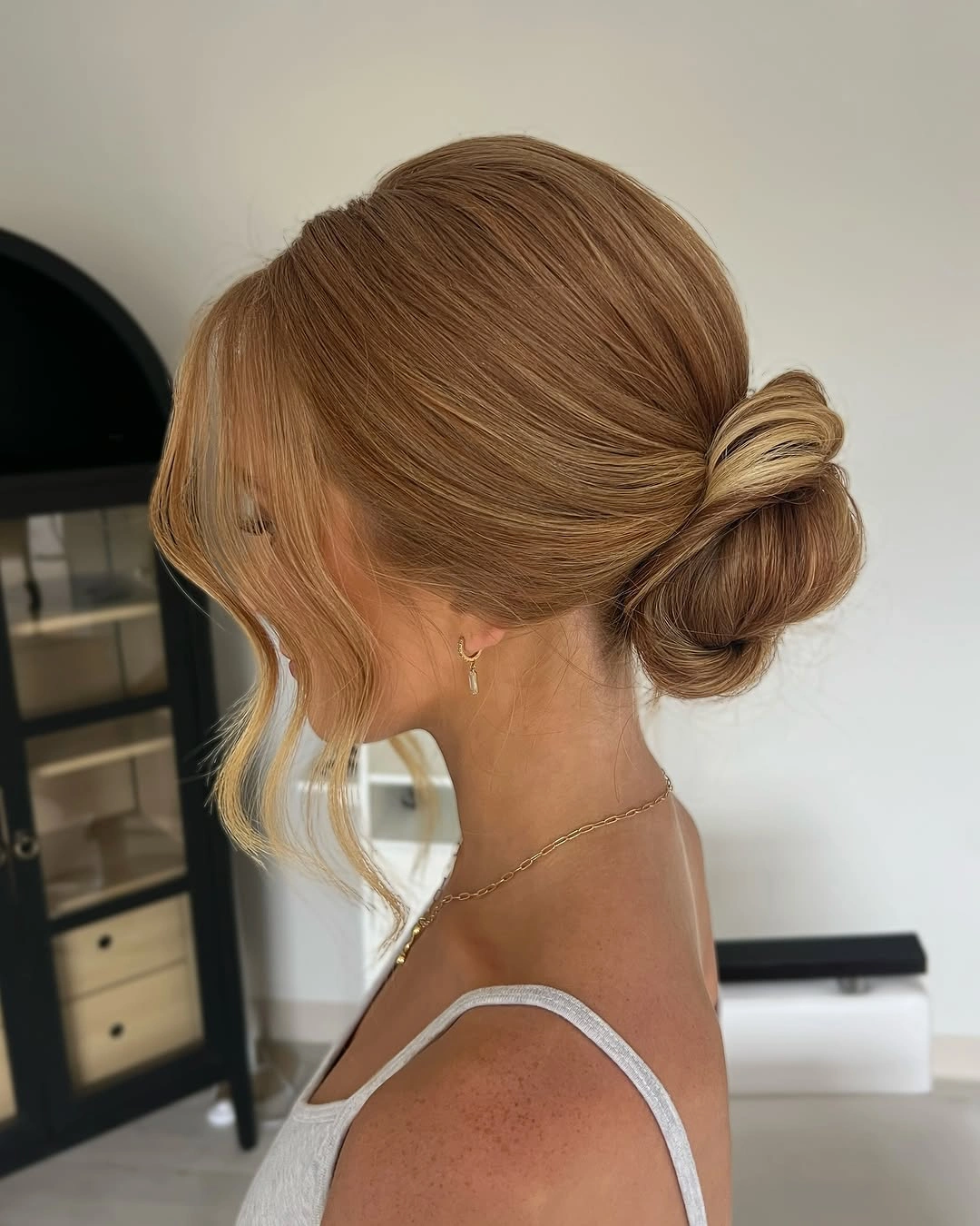 fall hairstyles for wedding guests 2026 Sleek Low Blonde Bun With Polished Front Pieces