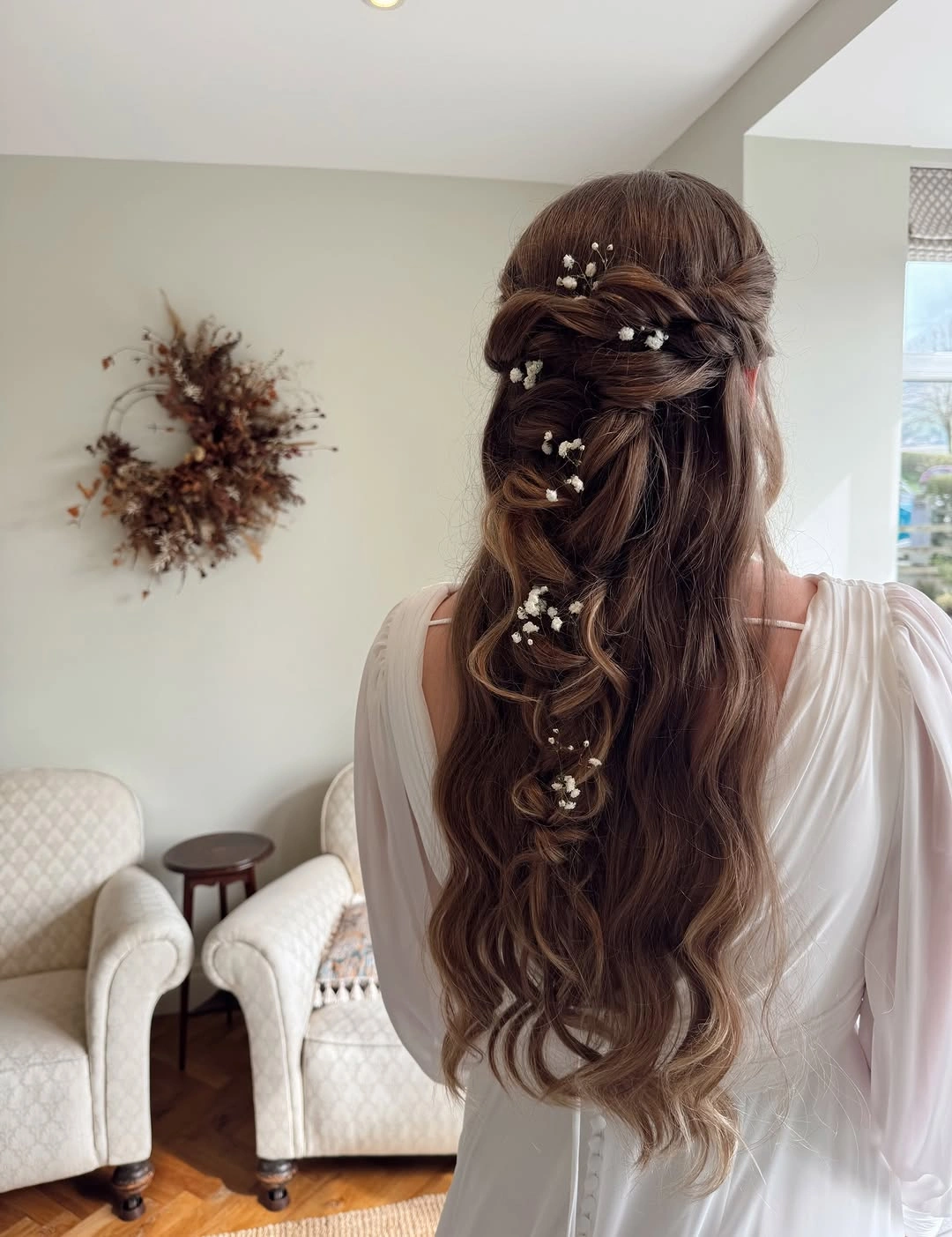 fall hairstyles for wedding guests 2026 Fairy-Tale Half-Up Waves With Baby’s Breath