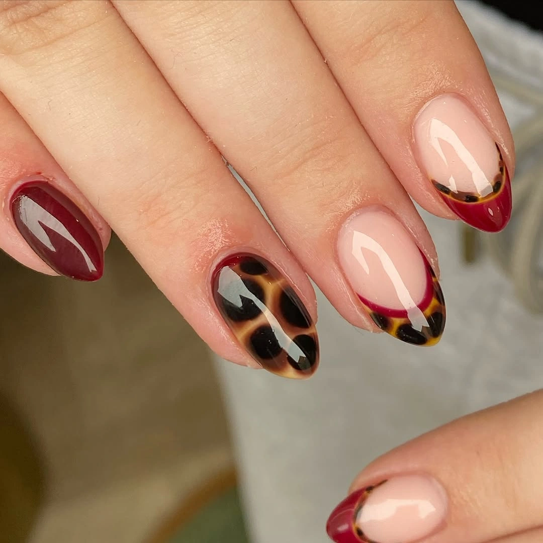 fall manicure 2026 Burgundy French Manicure With Leopard Accent