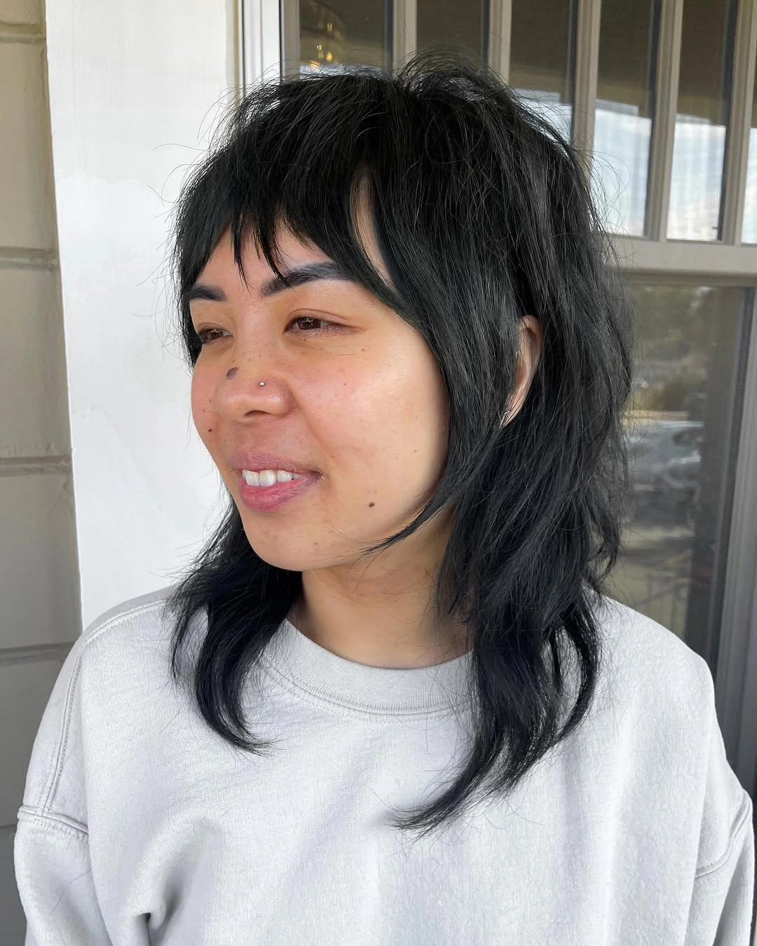 fall medium haircuts 2026 Messy Black Wolf Cut With Choppy Bangs
