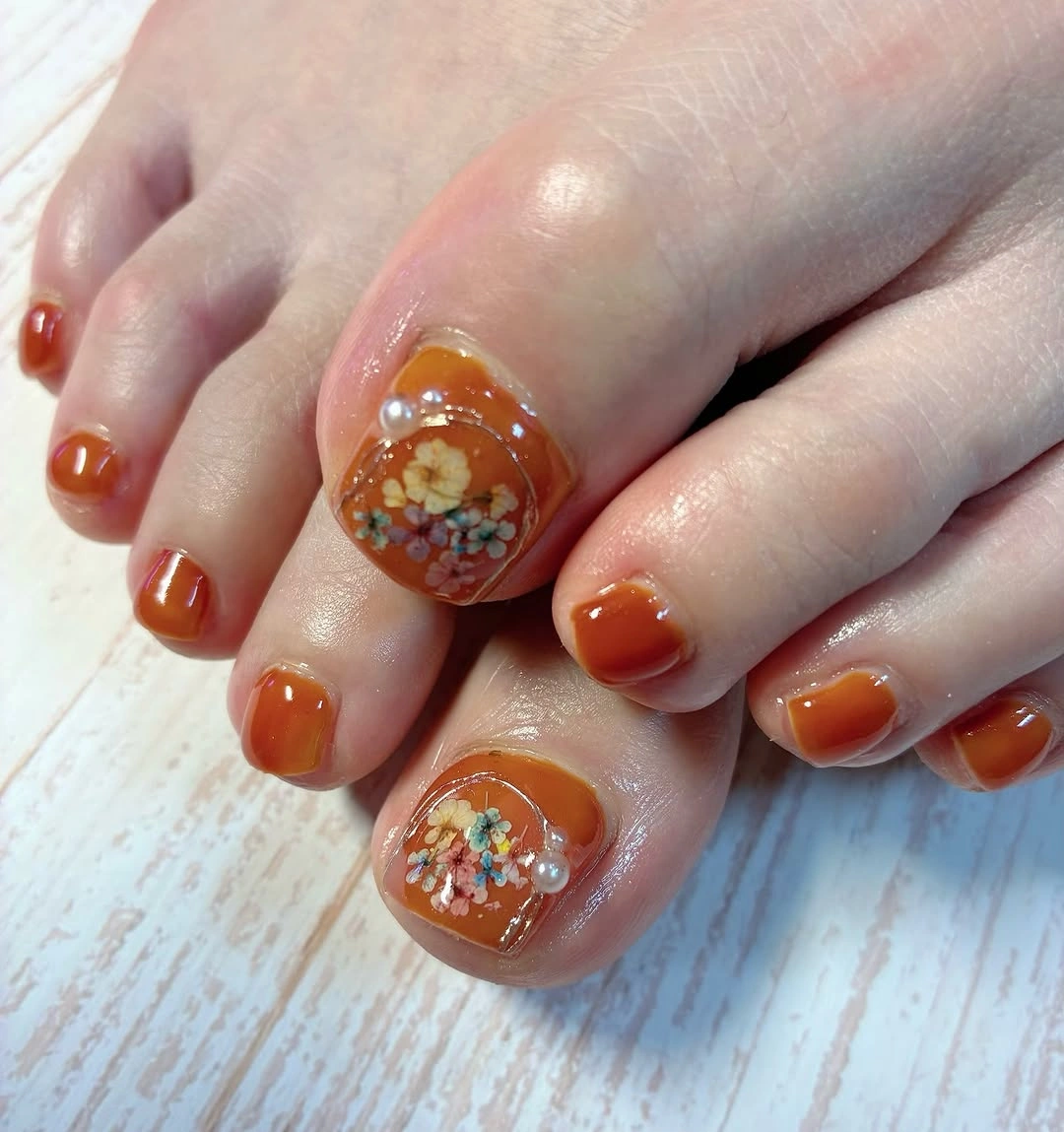 fall pedicure ideas 2026 Orange Floral Pedicure With Clear Accent Big Toes