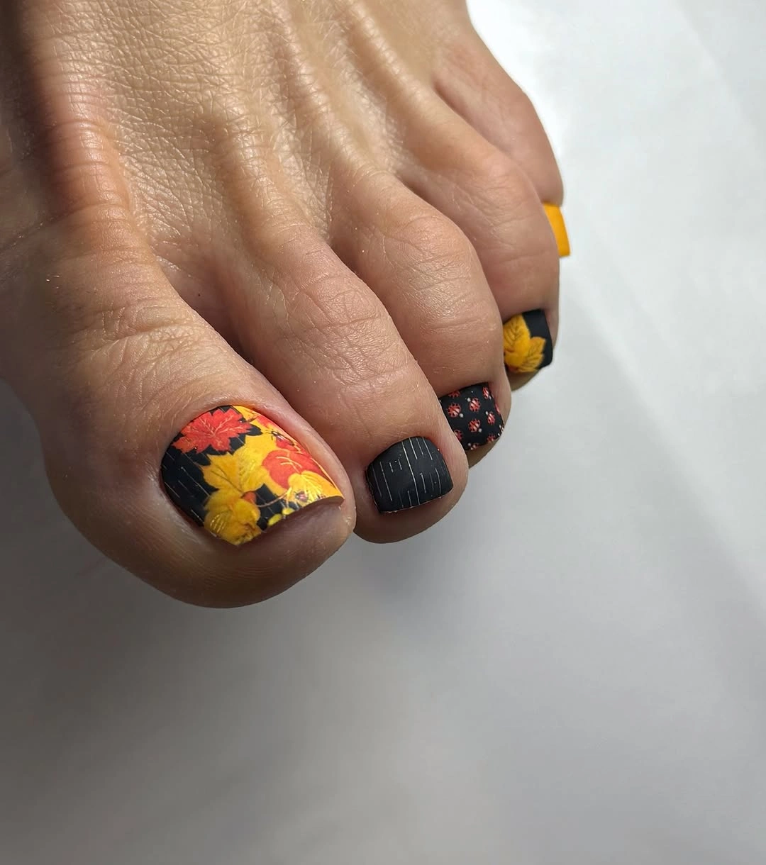 fall pedicure ideas 2026 Black Floral Pedicure With Yellow Fall Accent