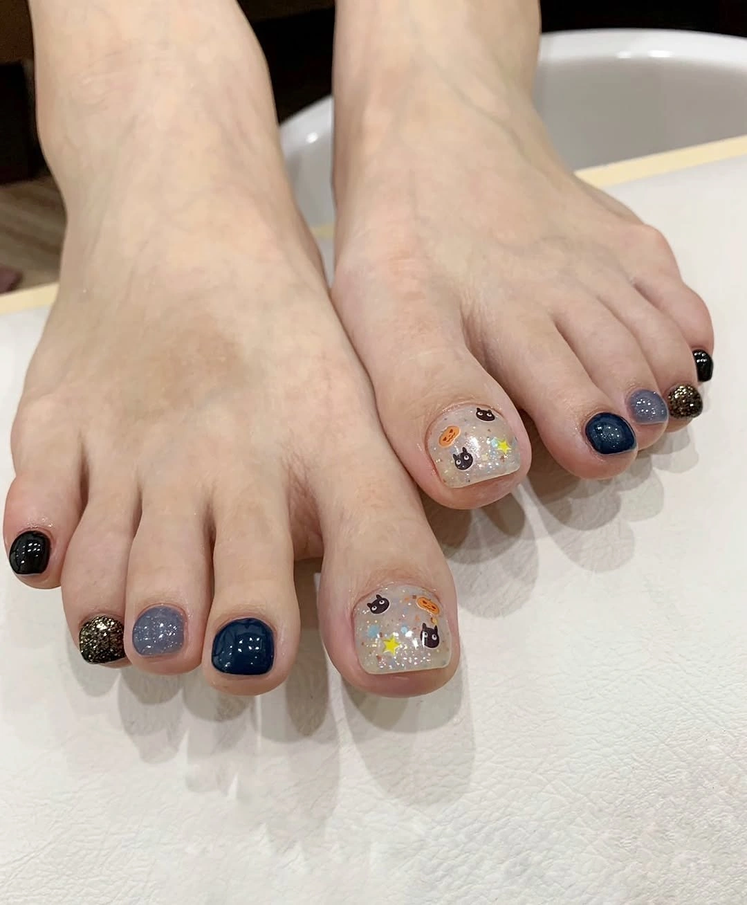 fall pedicure ideas 2026 Navy Glitter Pedicure With Small Floral Details