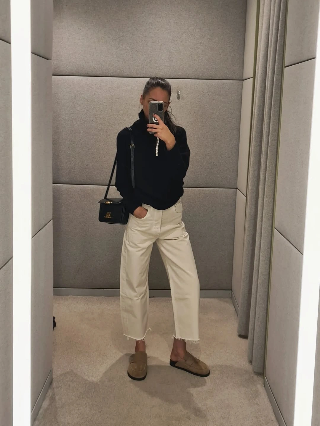 fall professional outfits women 2026 Black Knitwear and Cream Jeans for an Elevated Minimalist Office Look