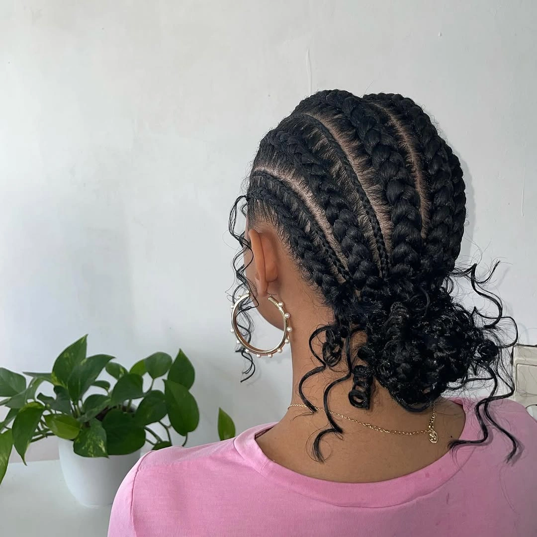 feed in braid hairstyles Feed-In Braids Gathered Into A Curly Low Bun