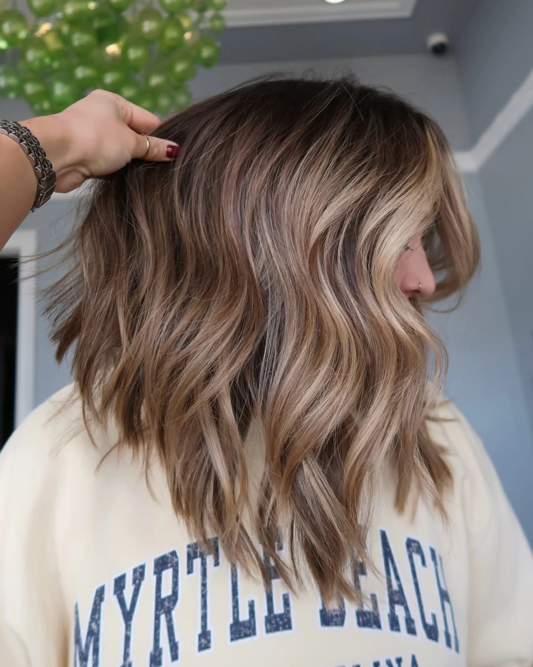 hair lowlights color ideas and inspiration Wavy Bronde Lob With Neutral Brown Pockets