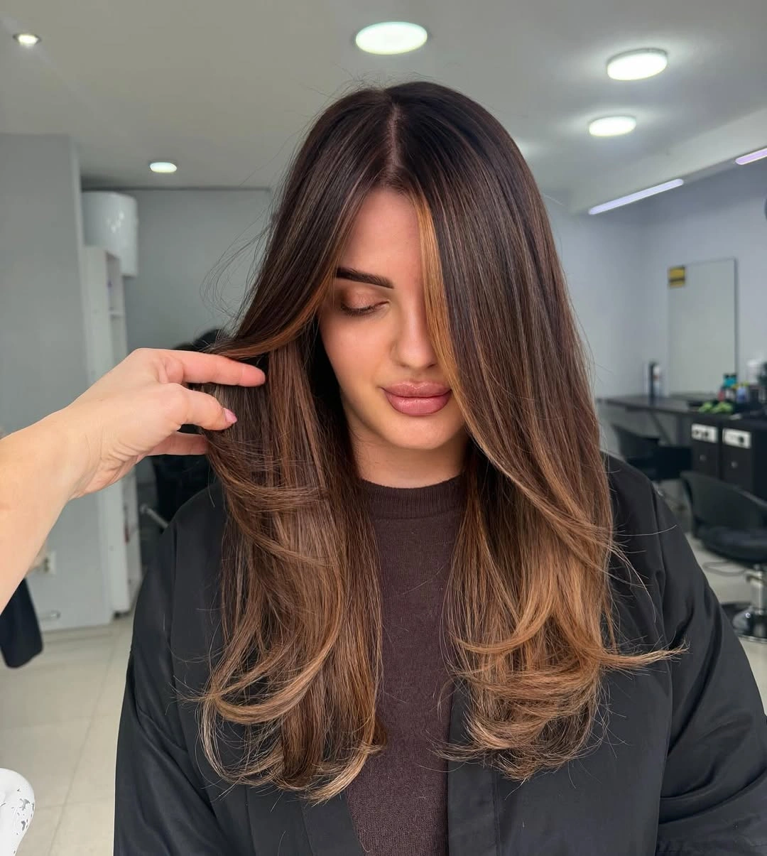 hair lowlights color ideas and inspiration Deep Brunette With Copper-Caramel Face Framing
