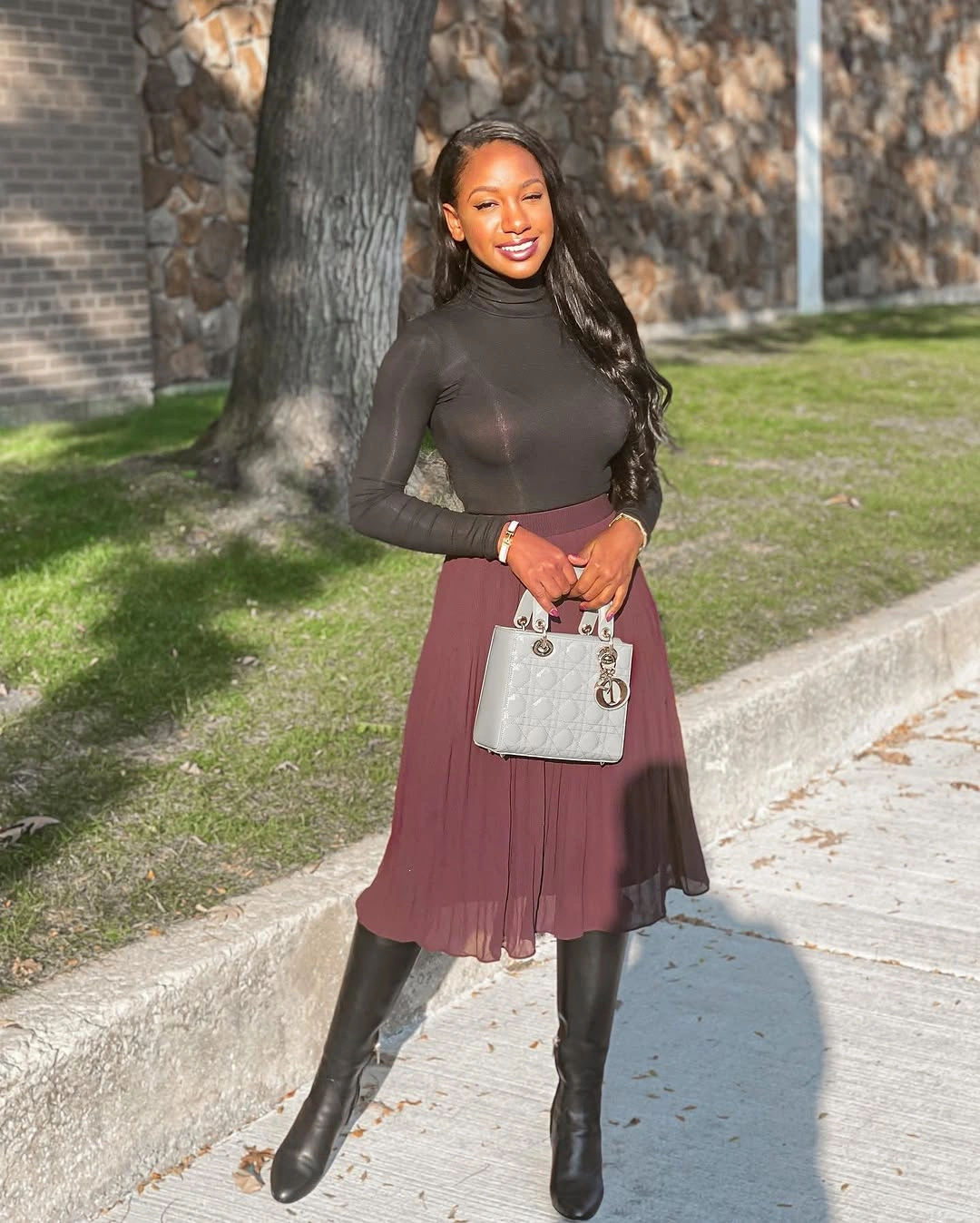 midi skirt fall outfit 2026 + Wine Pleats With a Black Turtleneck and Tall Boots