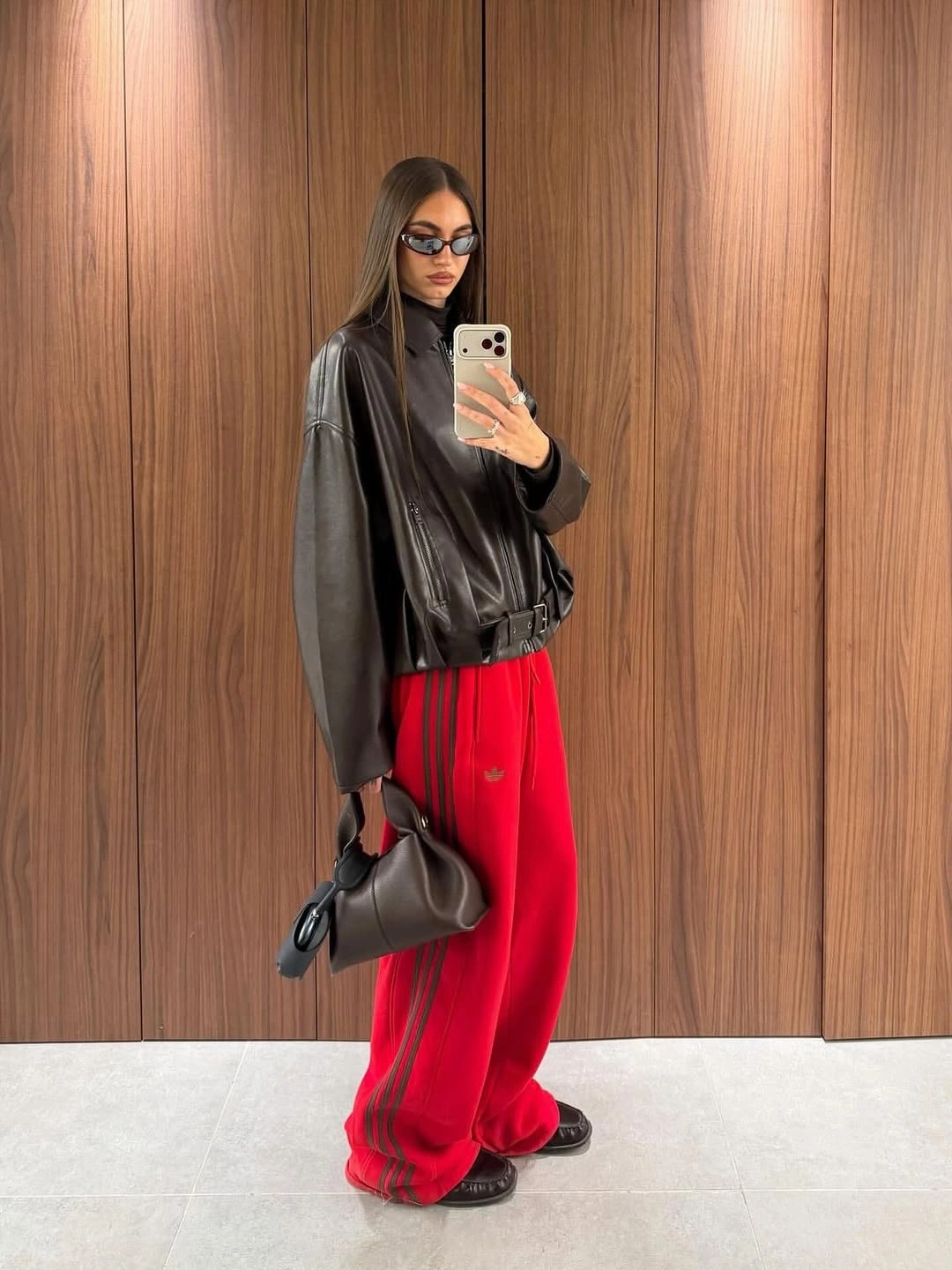 september fashion trends 2026 Black Leather Jacket With Bright Red Trousers