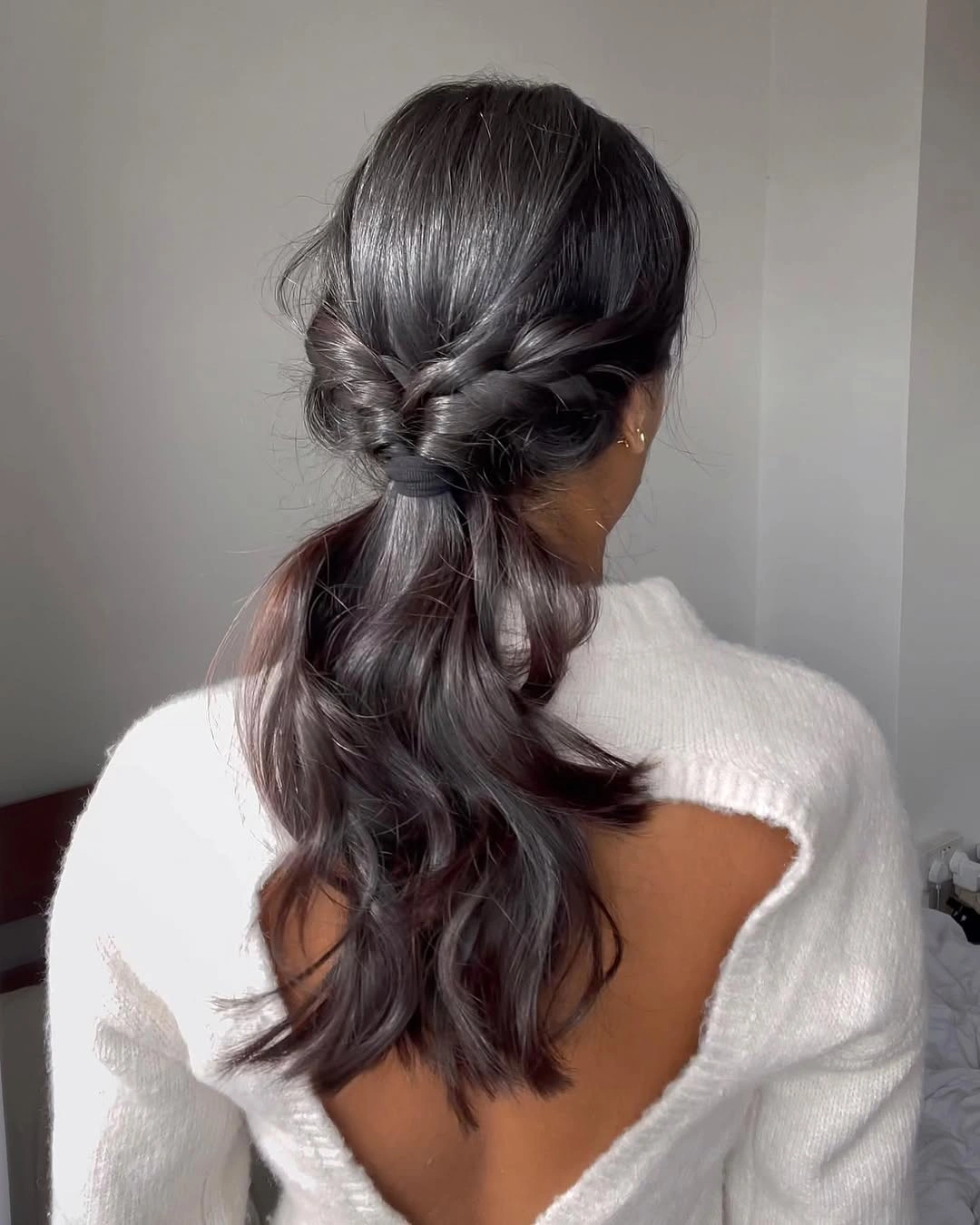 september hairstyles ideas 2026 Low Braided Ponytail With Dark Glossy Waves