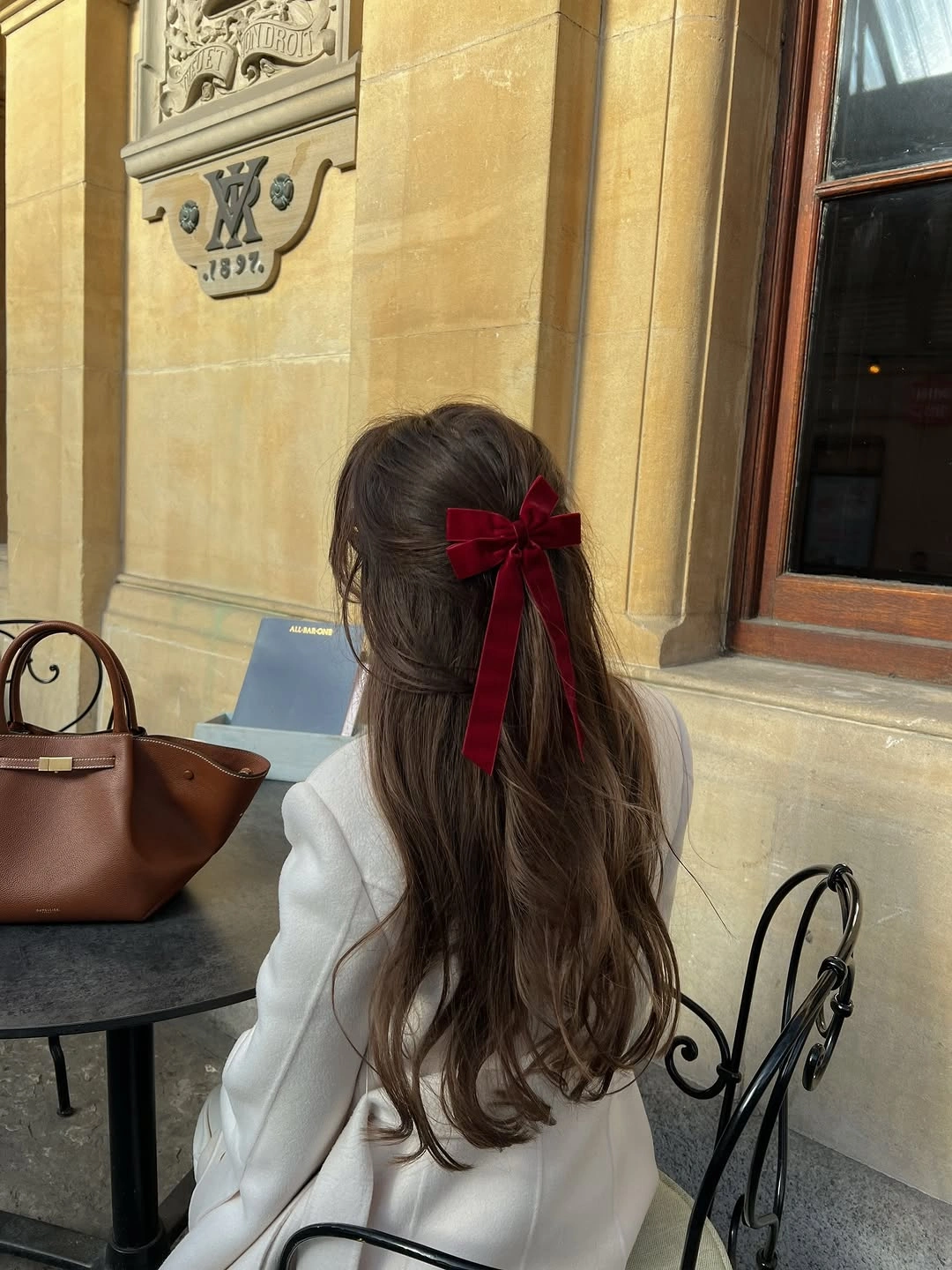 september hairstyles ideas 2026 Soft Brown Half-Up Style With Red Bow