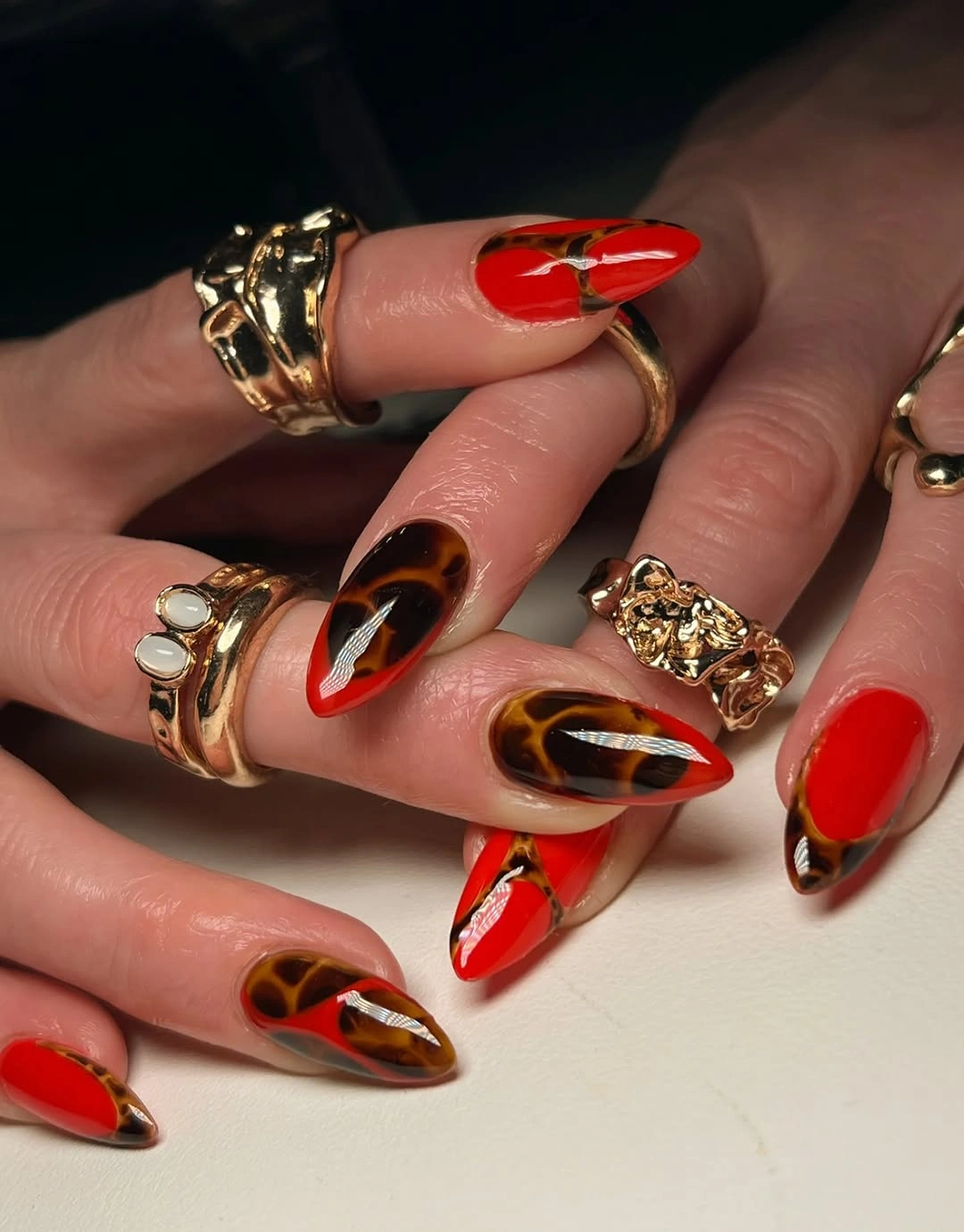 september nail art ideas 2026 Red and Tortoise Almond Nails with Heart Detail