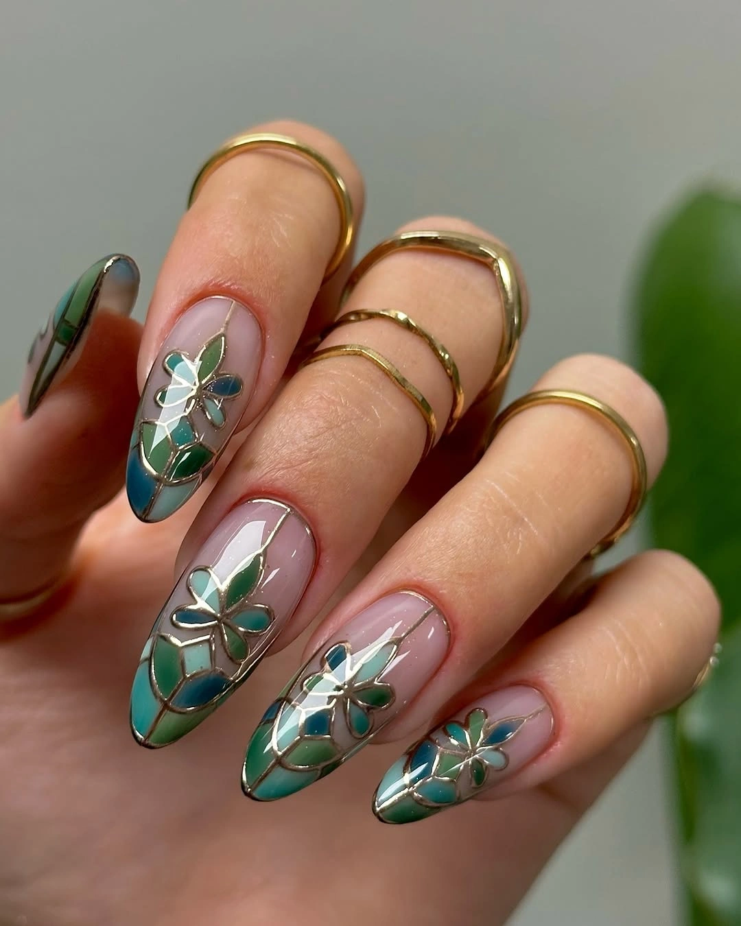september nail art ideas 2026 Green Floral Almond Nails with Stained-Glass Lines