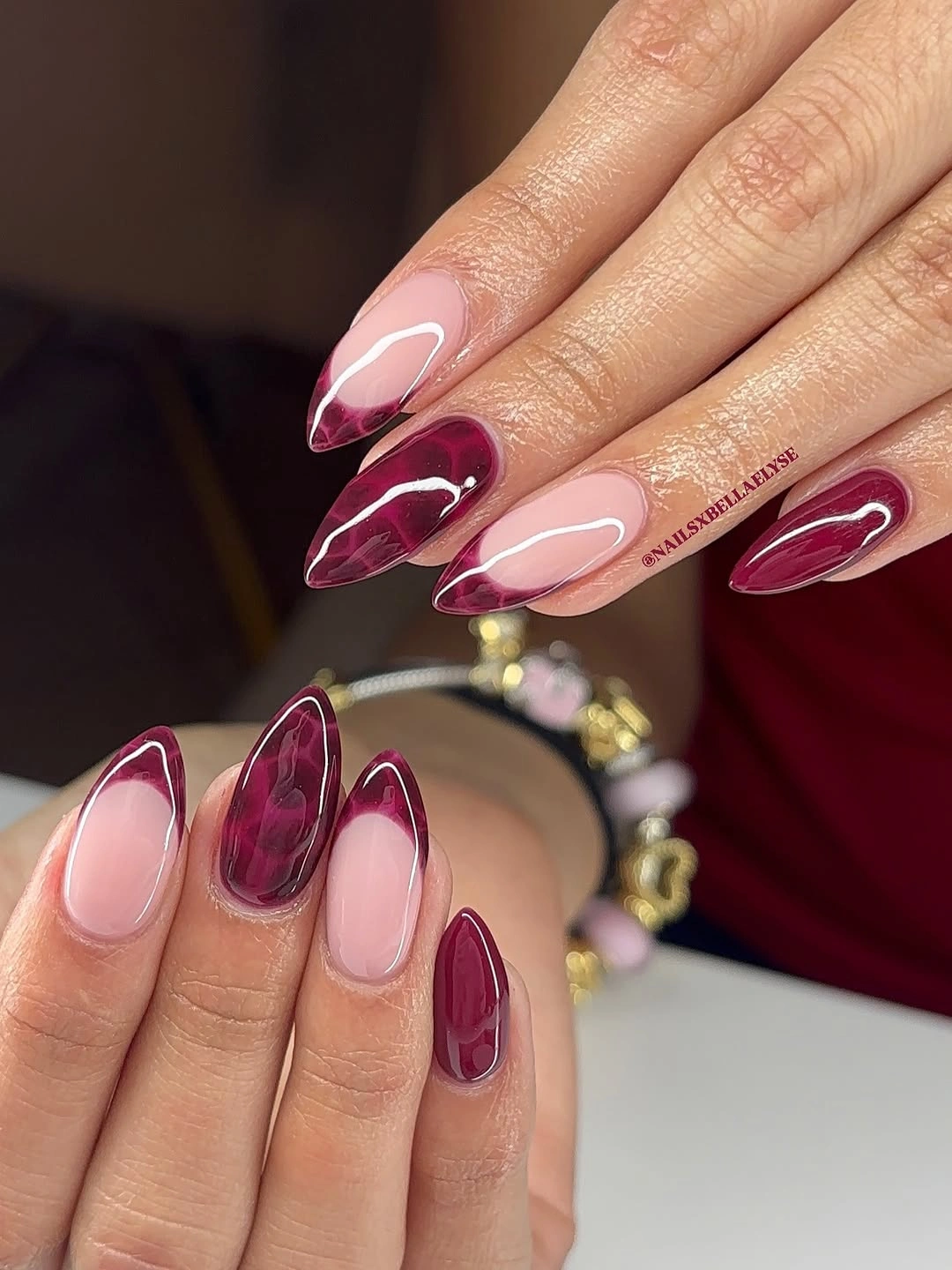 september nail designs 2026 Burgundy Marble Almond Nails on Sheer Pink