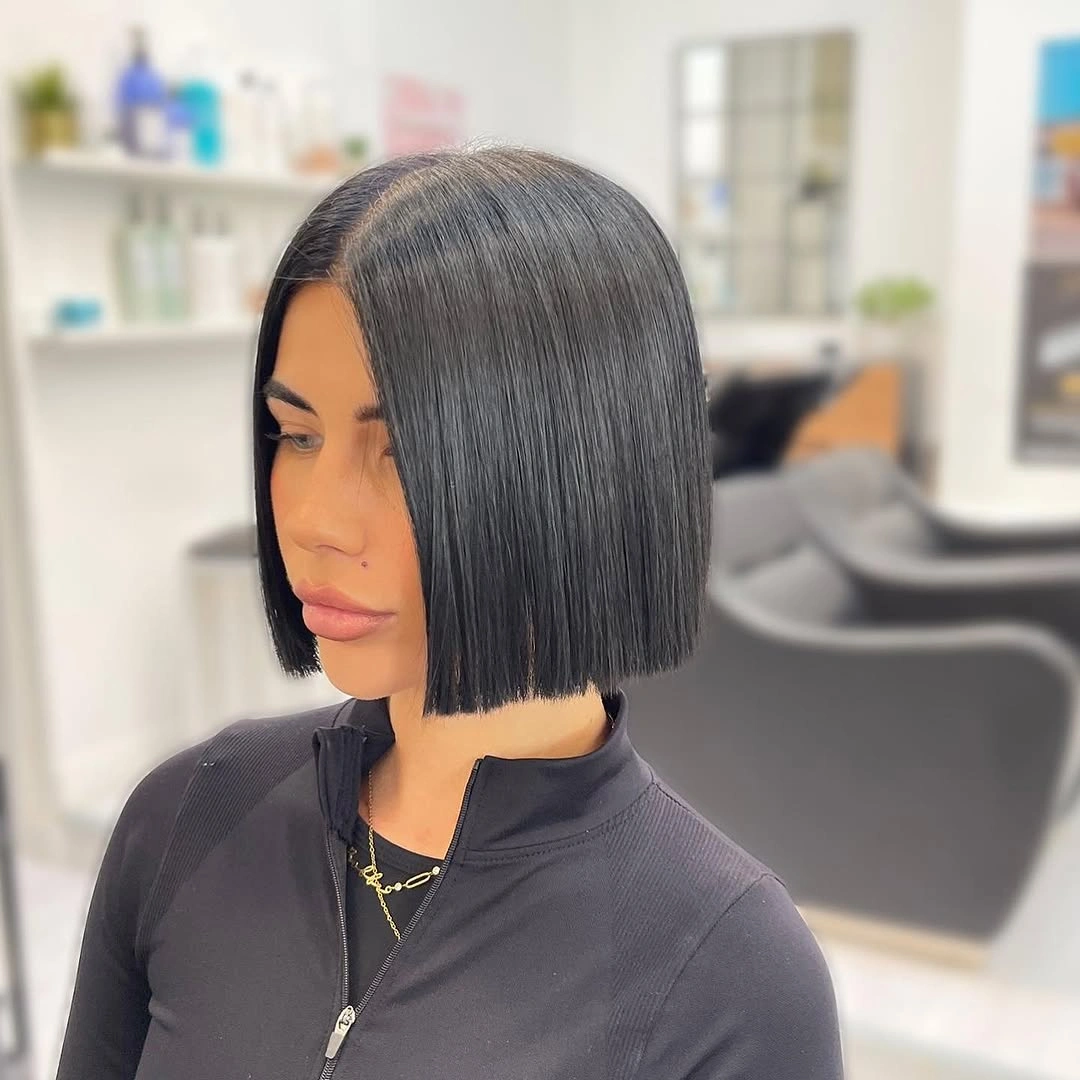 short bobbed hairstyle Ink-Black Center-Part Bob With a Razor Baseline