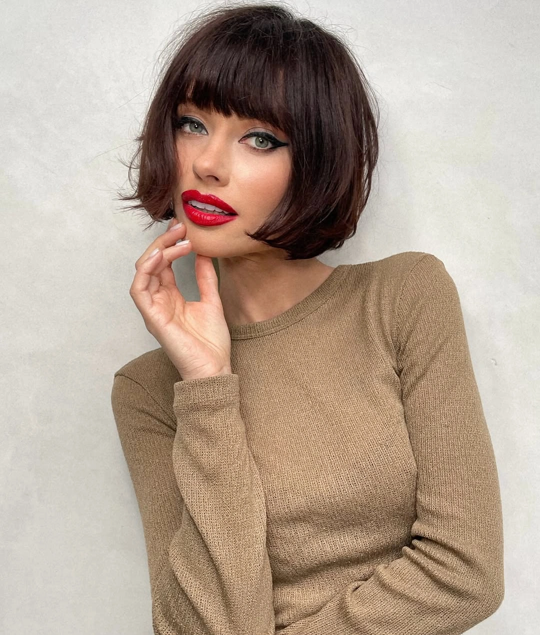 short bobbed hairstyle Retro Brunette Bob With Blunt Baby Bangs