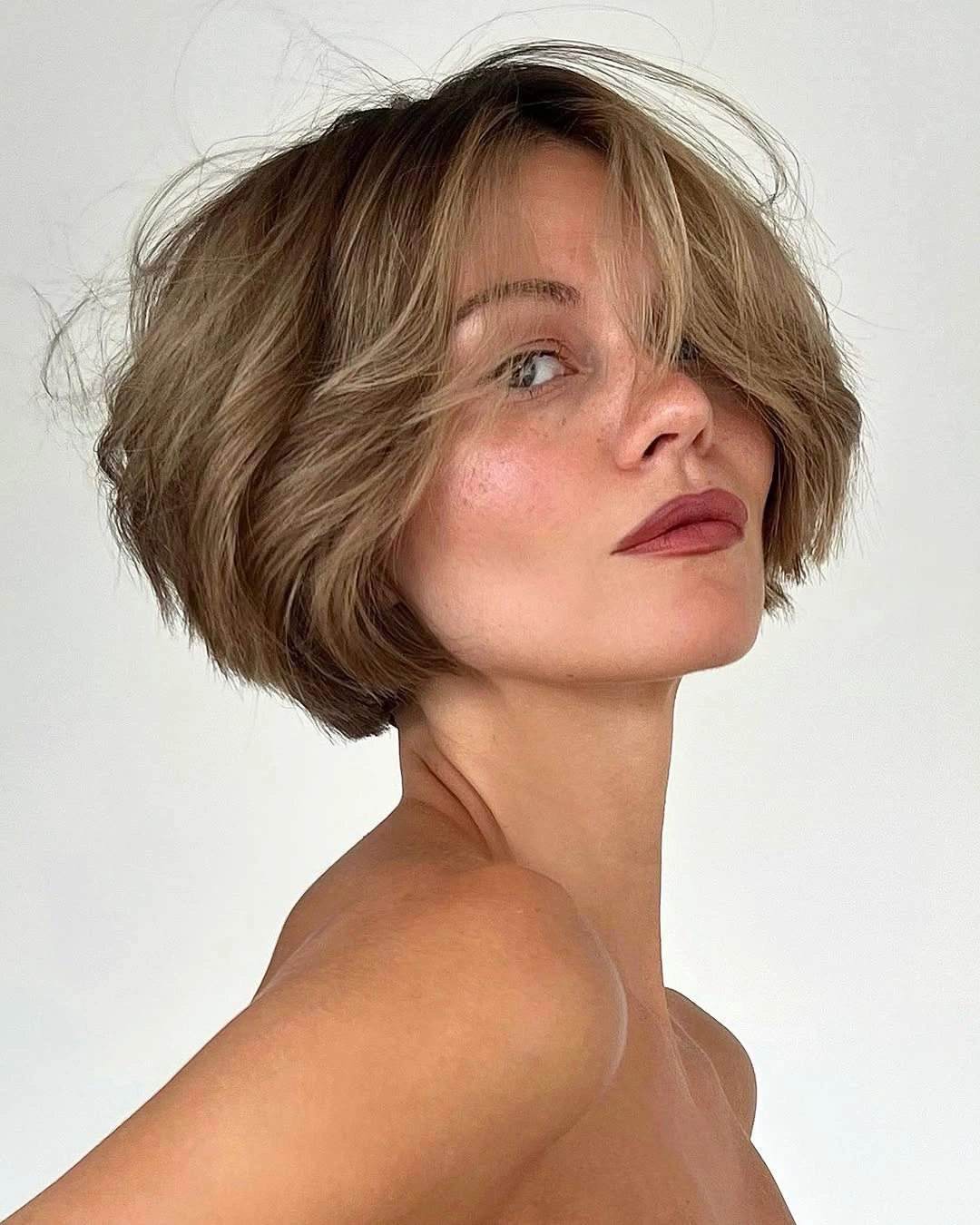 short bobbed hairstyle Airy Bronde French Bob With Long Curtain Fringe