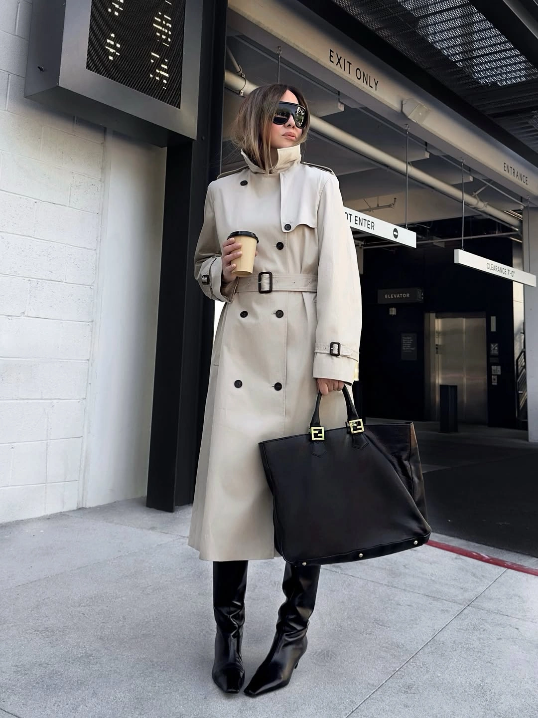 Trench coat fall outfits 2026 + Cream Double-Breasted Trench With Black Boots And A Large Tote