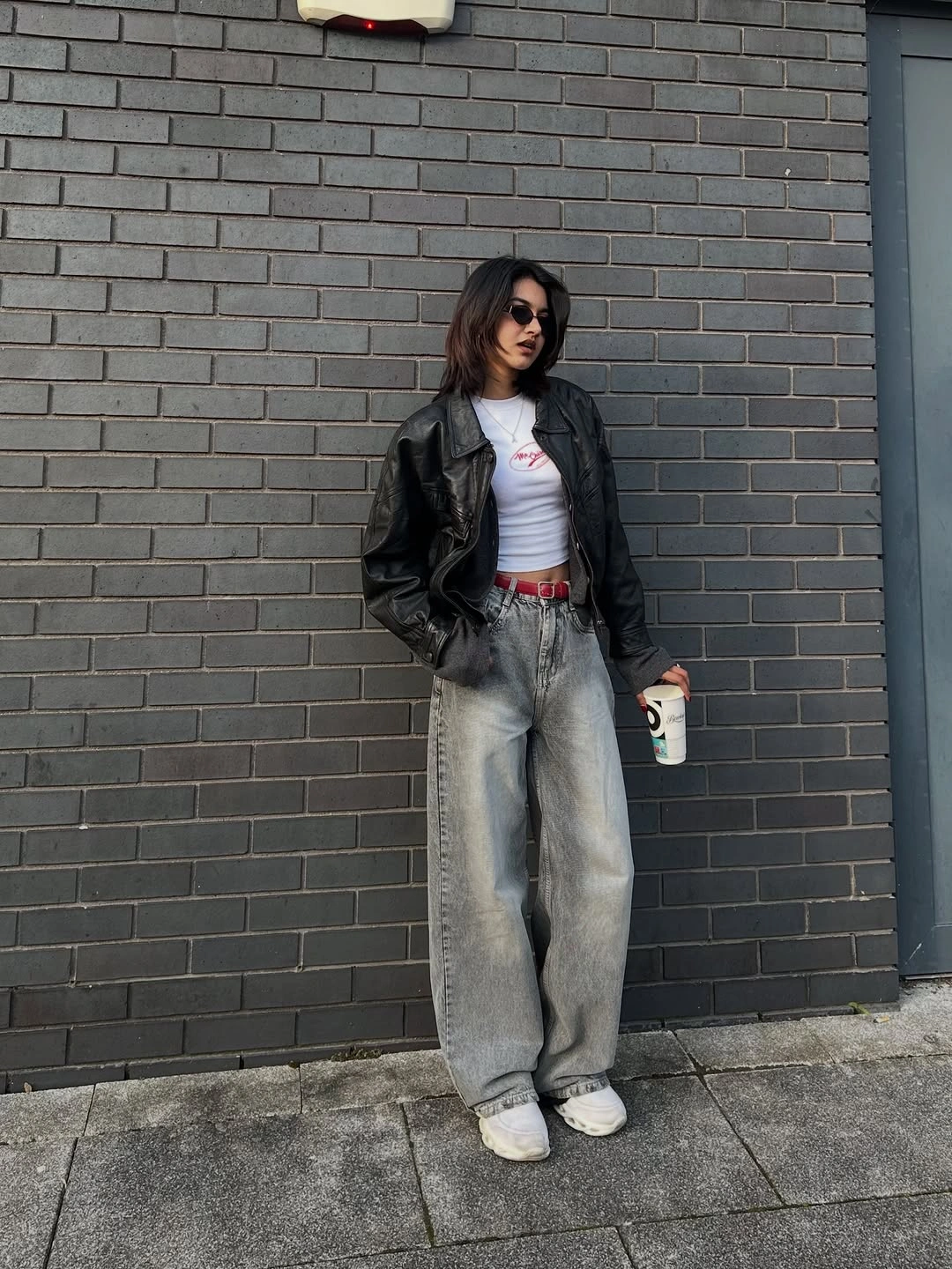 wide leg jeans outfit fall 2026 + Leather Jacket, Red Belt, and Gray Wide-Leg Denim
