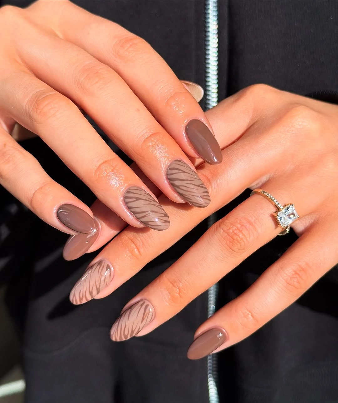 Taupe almond nails with pale curved line accents