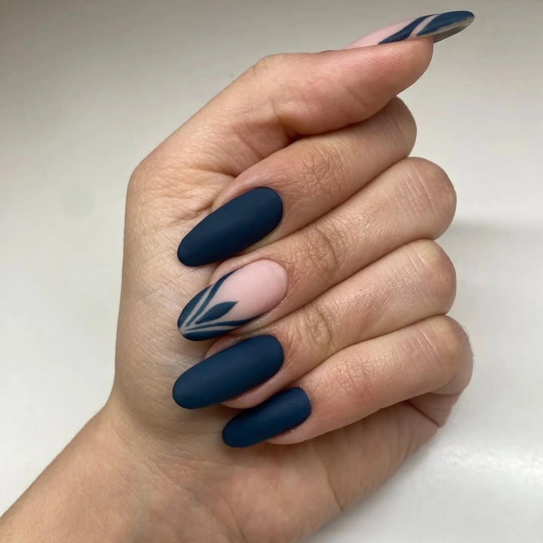 Navy matte almond nails with nude botanical line accents