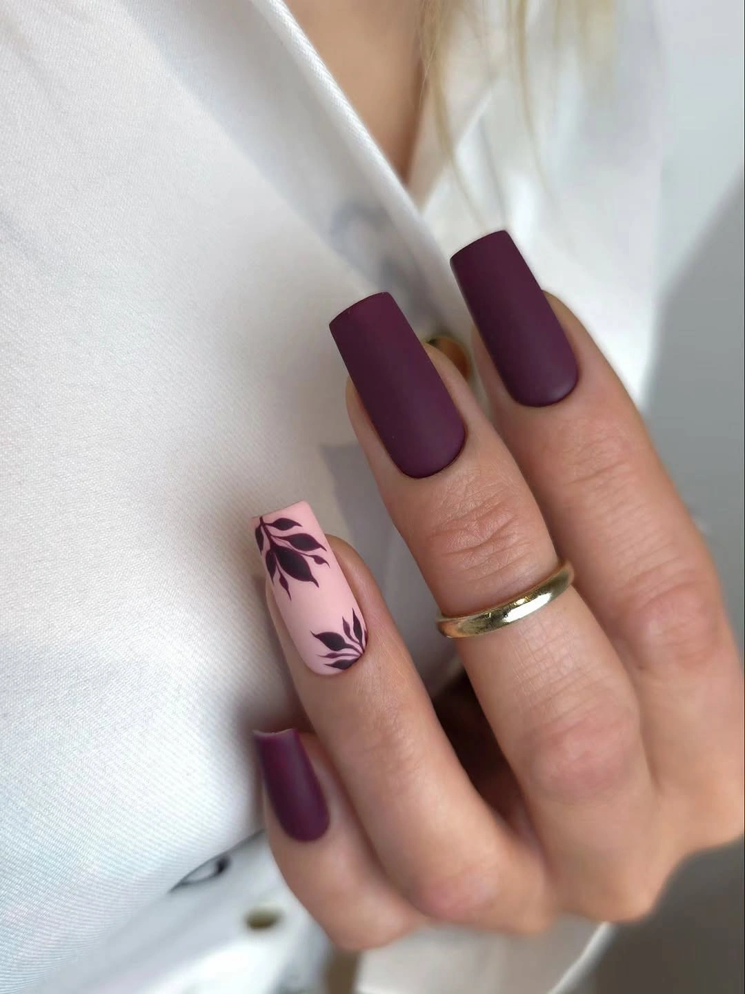 Long plum matte square nails with a pink leafy accent