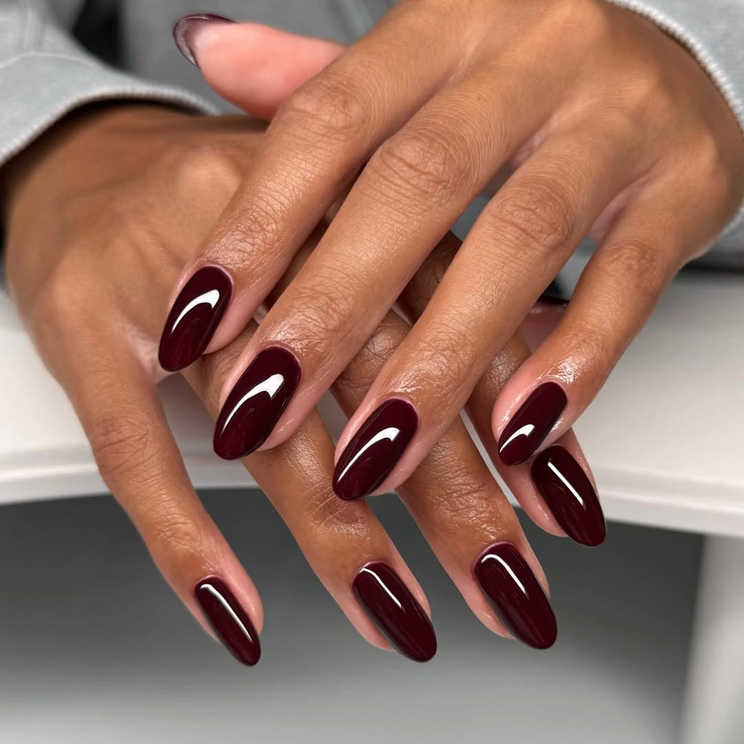 Medium-long almond nails with liquid-looking burgundy gloss