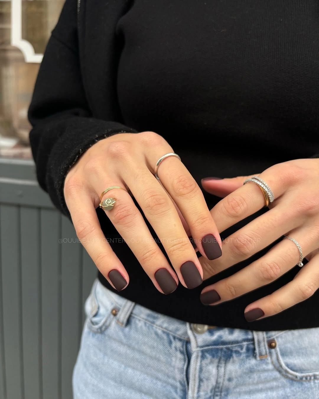 Short rounded dark plum matte nails with a minimal finish