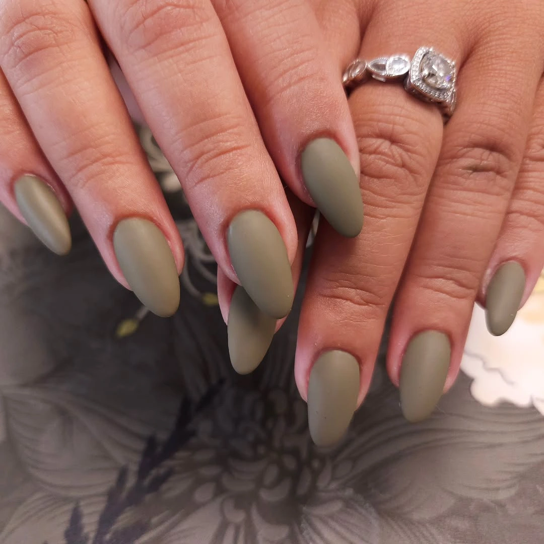 Medium almond nails in a uniform muted olive matte color