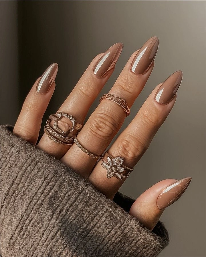 Long glossy taupe almond nails with warm neutral color