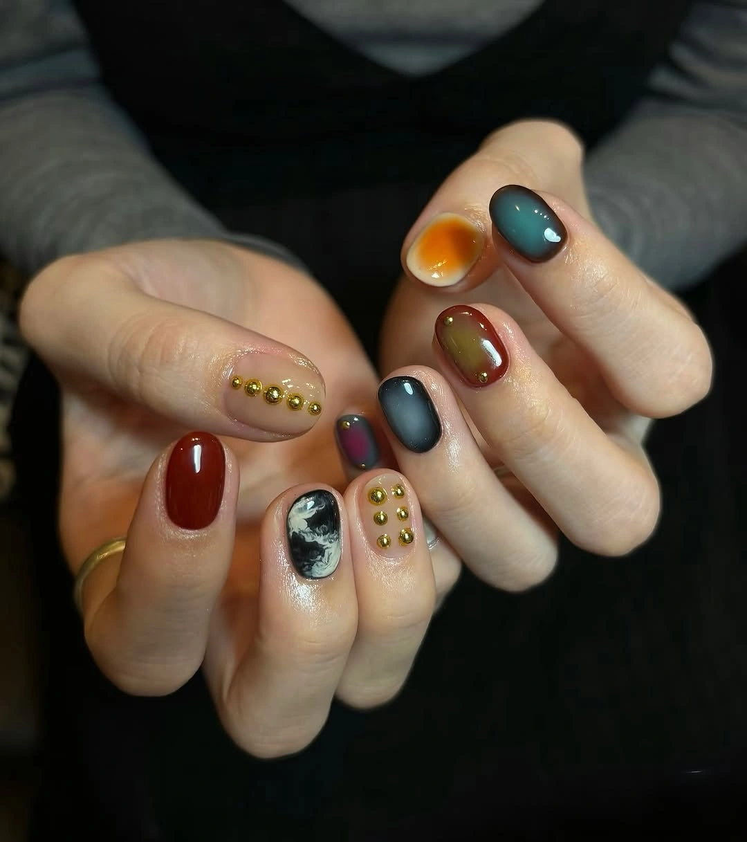 Short jewel tone nails with raised dots and mixed accents