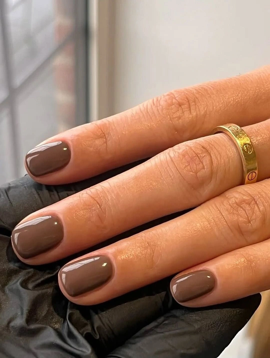 Short rounded square nails in a taupe brown glossy shade