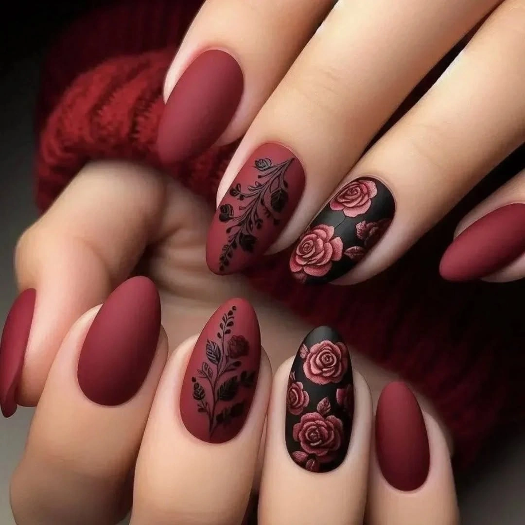 Burgundy matte almond nails with dark floral accent art