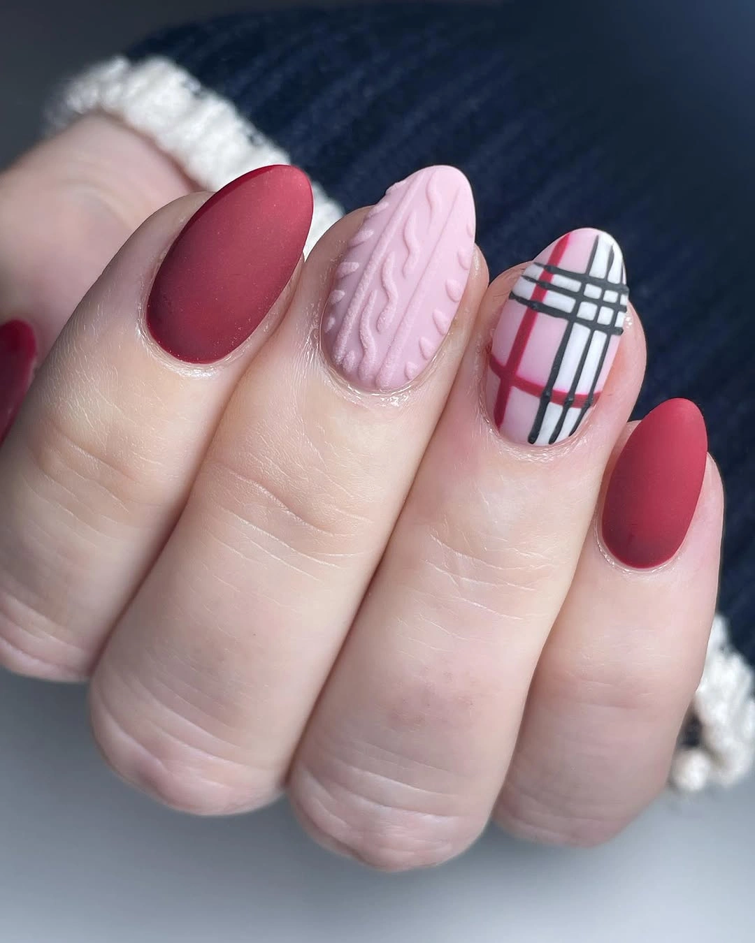 Burgundy matte oval nails with pink texture and plaid accents