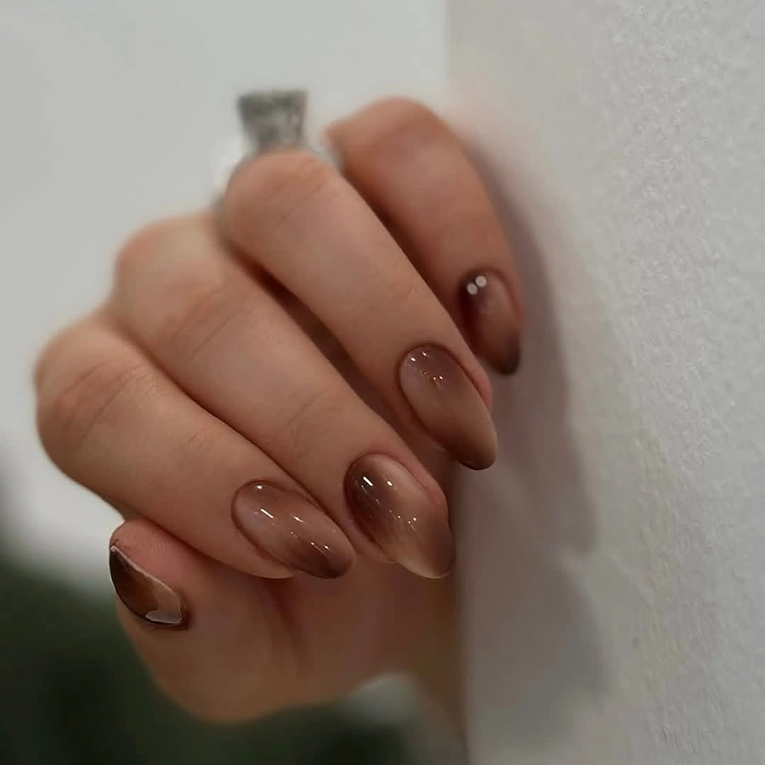 translucent brown almond nails with a glossy finish