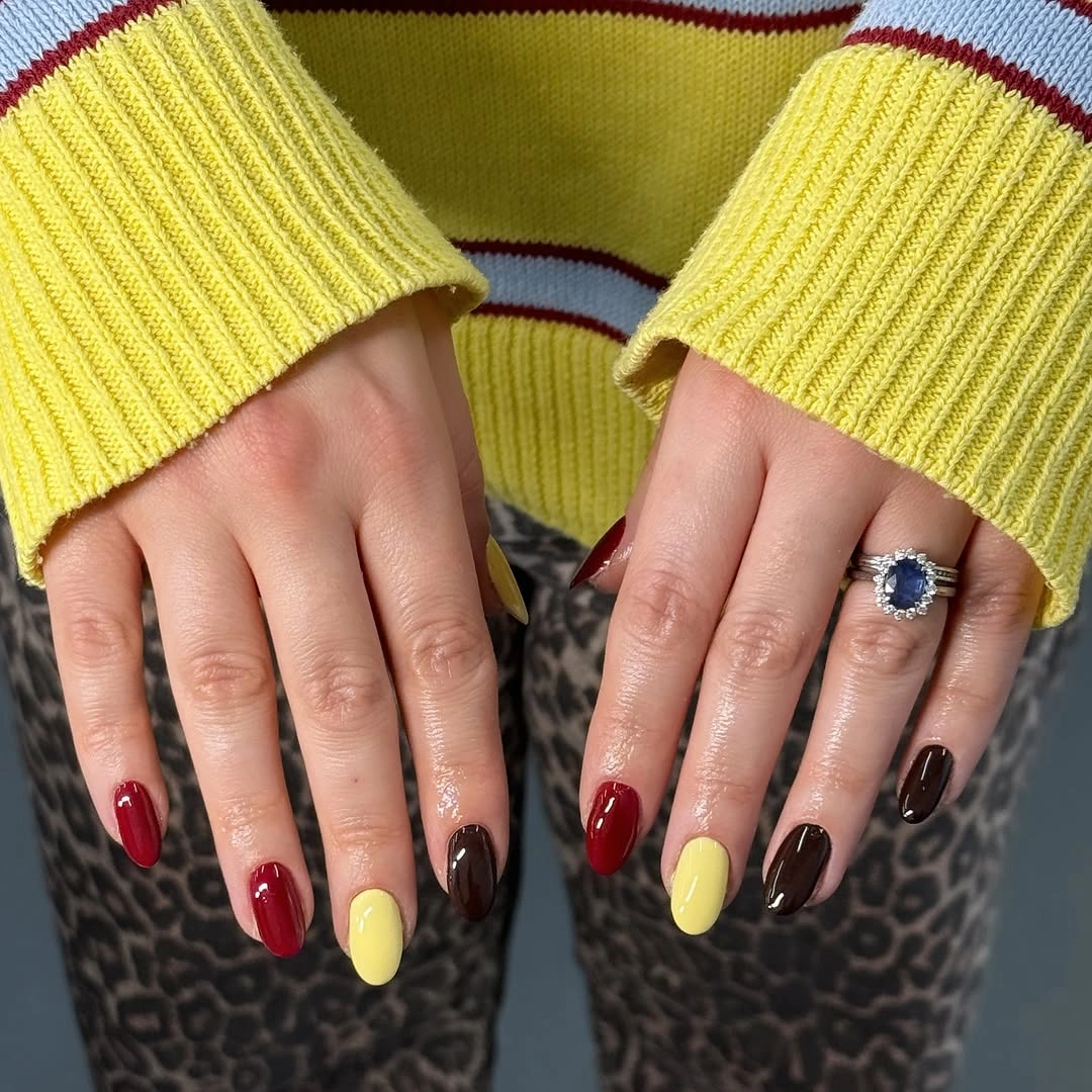 short rounded nails in deep red brown and yellow blocks