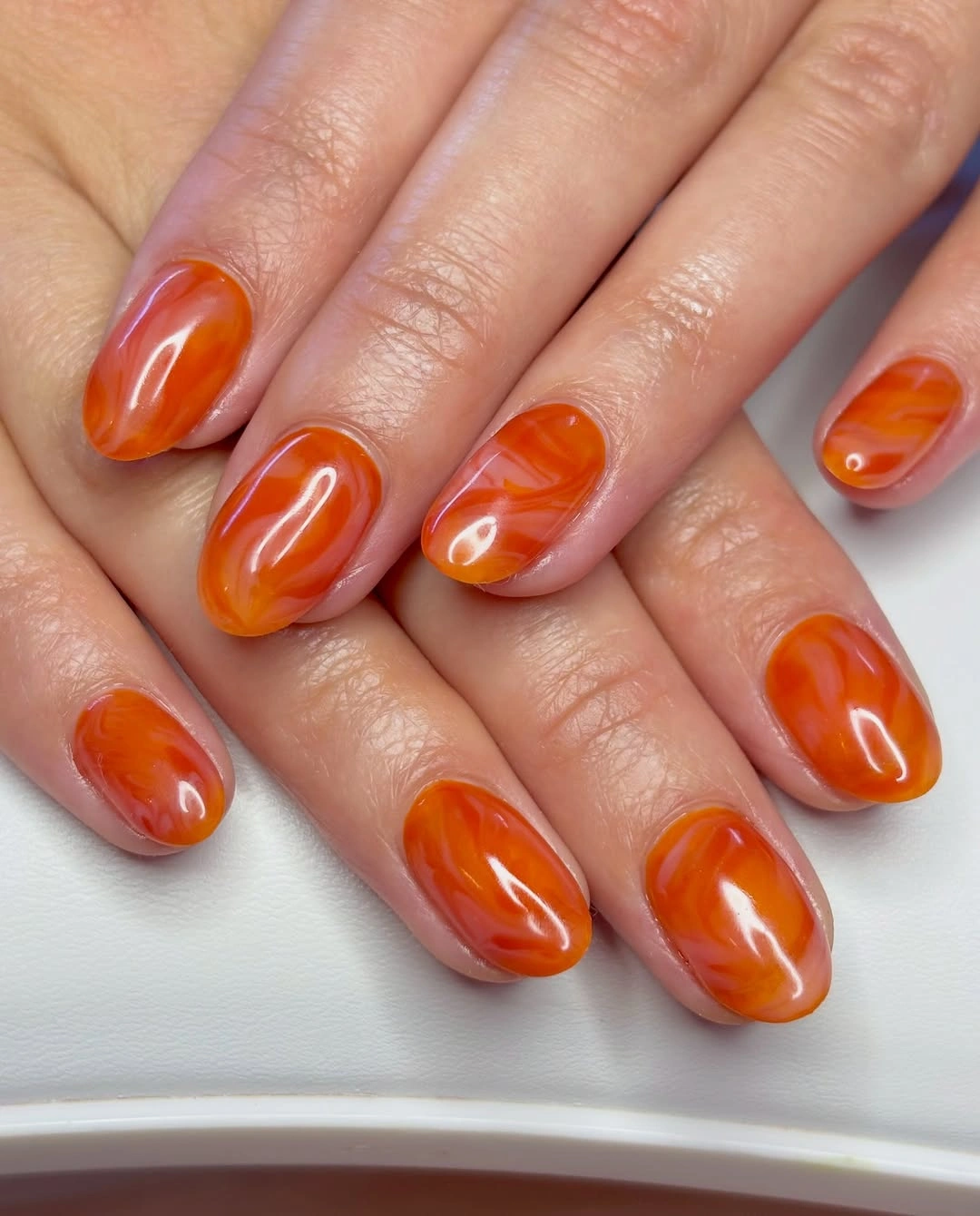 long pointed nude nails with fine gold line accents