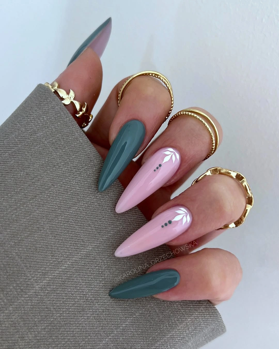 long pointed teal and lilac nails with white marks